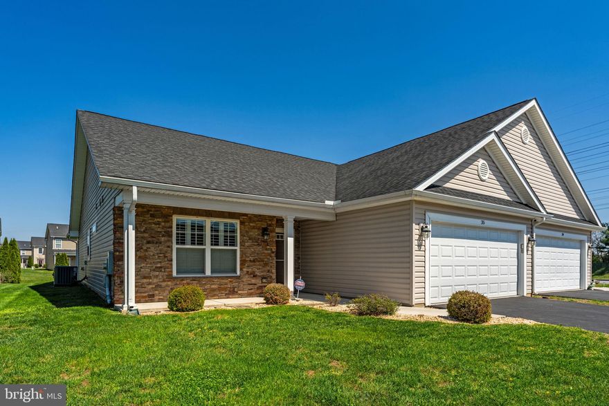 Situated on a  cul-de-sac in the desirable Spring Mills community, this beautifully maintained one-level villa offers comfort, style, and easy living in all the right ways. With 2 bedrooms, 2 full baths, and 1,677 square feet, the layout is designed for both everyday enjoyment and effortless entertaining.

At the heart of the home, the open kitchen, dining, and living areas create a warm and inviting gathering space. Luxury vinyl plank flooring runs throughout, adding a clean, cohesive look, while the kitchen features stainless steel appliances, granite countertops, and a center island that makes meal prep and casual conversation easy. Plantation shutters add timeless charm, and both bedrooms feature tray ceilings and ceiling fans for an added touch of character.

The primary suite offers a relaxing retreat with two walk-in closets and a private bath featuring a glass-enclosed walk-in shower. A second bedroom and full bath provide flexible space for guests, a home office, or both. The attached 2-car garage with opener, dedicated laundry room, security system, welcoming front porch, and rear concrete patio add convenience and comfort to daily life.

Beyond the home itself, Spring Mills offers a lifestyle many buyers are looking for, with access to walking trails, an Olympic-sized community pool, tennis, pickleball and basketball courts, playgrounds, a clubhouse, and community activities. The location also provides easy access to I-81, Route 11, the MARC train in Martinsburg, and nearby shopping, dining, and services at Spring Mills Towne Center.