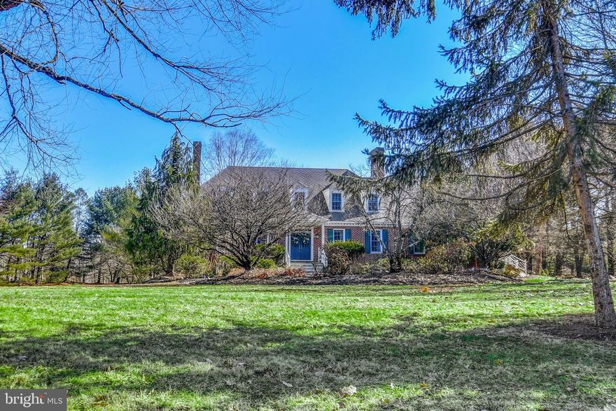 Set on 2.4 acres on a quiet Saucon Valley Road, this classic home was designed to embrace the elements of a Williamsburg Colonial. It has been stylishly updated and was featured in Lehigh Valley Style Magazine. Boasting over 5,000 square feet of family space on three levels, this quietly sophisticated home is well-planned and beautifully executed. Hardwood floors accent most first floor rooms. There is a stunning Plato kitchen boasting a blend of aesthetics and functionality, with high-end appliances including Viking, Subzero and Dacor. Wood cabinetry, granite counters, brick alcove, Portuguese tile, two sinks, center island and serving area are guaranteed to impress. A gracious dining room and living room have detailed moldings and a fireplace. A central family room is anchored by a second fireplace, detailed with custom cabinetry, all opening to a covered porch, full patio, and a yard shaded by fabulous old trees. The adjacent sunroom has a beadboard ceiling, three walls of windows, and is perfect for extended entertaining. Completing the first floor is a sophisticated primary bedroom with luxurious bath, a mud room and a laundry room. Upstairs, there are 3 additional bedrooms, two baths, and an office/family room. Sure to please, the lower level offers a recreation room, a family room with custom bar, and plenty of storage and workshop space. A two-car garage completes this level. Close to Historic Bethlehem, the Saucon Valley Country Club and Lehigh Valley’s finest colleges and universities, the sophisticated location in lovely Saucon Valley is just one of many reasons to appreciate this exceptional home.