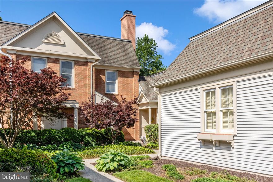This elegant courtyard-style townhome blends the ease of main-level living with timeless sophistication and warm, inviting spaces throughout. From the moment you step inside, you are welcomed by a gracious living room and formal dining room anchored by a stunning double-sided fireplace, creating an atmosphere that is both refined and comfortable — ideal for intimate evenings or effortless entertaining. 
The sunroom is a true highlight of the home, surrounded by walls of windows that fill the space with natural light and provide the perfect setting for quiet mornings, afternoon reading, or simply relaxing while enjoying the peaceful surroundings. Hardwood floors flow through the foyer, living room, dining room, sunroom, and second bedroom, adding warmth, character, and elegance throughout the main living areas. The light-filled kitchen offers both beauty and functionality with a spacious breakfast area, 42-inch cabinetry, and a center island topped with butcher block — an inviting space for casual dining and gathering. The spacious primary suite serves as a private retreat, featuring abundant closet space and a beautifully appointed ensuite bath complete with a double vanity, updated oversized shower, and separate soaking tub. A comfortable guest bedroom and full guest bath provide welcoming accommodations for family and visitors alike. Step outside to the private patio, where the newly installed awning creates a charming outdoor retreat perfect for dining al fresco, entertaining guests, or simply unwinding while enjoying the lovely setting. Recent updates include replacement windows, a new patio and awning, recently painted exterior wood trim, sump pump (2024), water heater (2022), and roof (2015), offering both comfort and peace of mind. Additional features include a one-car garage and a full unfinished lower level ideal for storage or future expansion. Located in the highly sought-after Wormans Mill community, residents enjoy exceptional amenities including a clubhouse, outdoor pool, walking trails, playgrounds, tennis and basketball courts, along with convenient access to shopping, dining, and commuter routes. This beautifully maintained home offers the perfect balance of elegance, comfort, and low-maintenance community living.