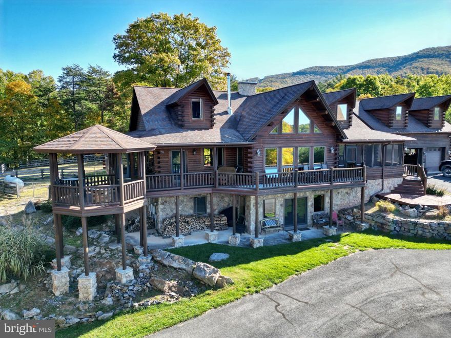 Stunning 4-Bedroom, 6-Bathroom Log Home on 27 Acres in Moorefield, WV

Discover the ultimate mountain retreat with this exquisite log home, offering nearly 5,000 sq. ft. of living space on 27 heavily wooded acres in a secure, gated community. The property features breathtaking western views and is the ideal spot for family living, weekend getaways, or even a hunting lodge. Located just 2.5 hours from Washington, D.C., this home is a rare find.

This beautiful 4-bedroom, 6-bathroom home is set atop a hill, offering spectacular 180-degree mountain views. The open-concept design highlights natural wood finishes, soaring ceilings, and large windows that flood the space with light. The heart of the home is the great room, featuring a grand stone fireplace – perfect for cozy evenings. A beautiful kitchen with granite counters, and a spacious island makes entertaining easy, while offering stunning views from every angle.

The luxurious master suite is a true sanctuary, complete with a spa-like bathroom. Upstairs, you'll find generously sized guest bedrooms and a loft area, ideal for a reading nook or office space. The full basement offers additional storage or ready for your growing family, and the 3-car garage provides plenty of room for vehicles and outdoor equipment. The home also includes a propane-powered automatic generator, ensuring you’re always powered up.

Outside, you'll find a  pond with a dock and gazebo just below the home, perfect for fishing or relaxing by the water. A small hunting cabin sits at the bottom of the property, equipped with electricity and a porch for extra outdoor enjoyment. ATV trails wind through the property, making it ideal for hunting, exploring, or hiking.

The adequate fenced yard is perfect for pets, and the property is surrounded by mature trees, providing privacy and peace. There's also a carport and additional storage space above the garage, with great lighting for added convenience. The paved, 3,000-foot private driveway ensures easy access to the home, and the community’s gated entrance offers added security.

Whether you're looking for a peaceful mountain home, a weekend retreat, or a hunting cabin, this property has it all. With 27 acres of land to explore, you’ll have all the space you need to enjoy the great outdoors. Plus, it's just a short drive from the town of Moorefield, offering convenient access to local amenities.

Don't miss your chance to own this exceptional log home. Schedule a private tour today!