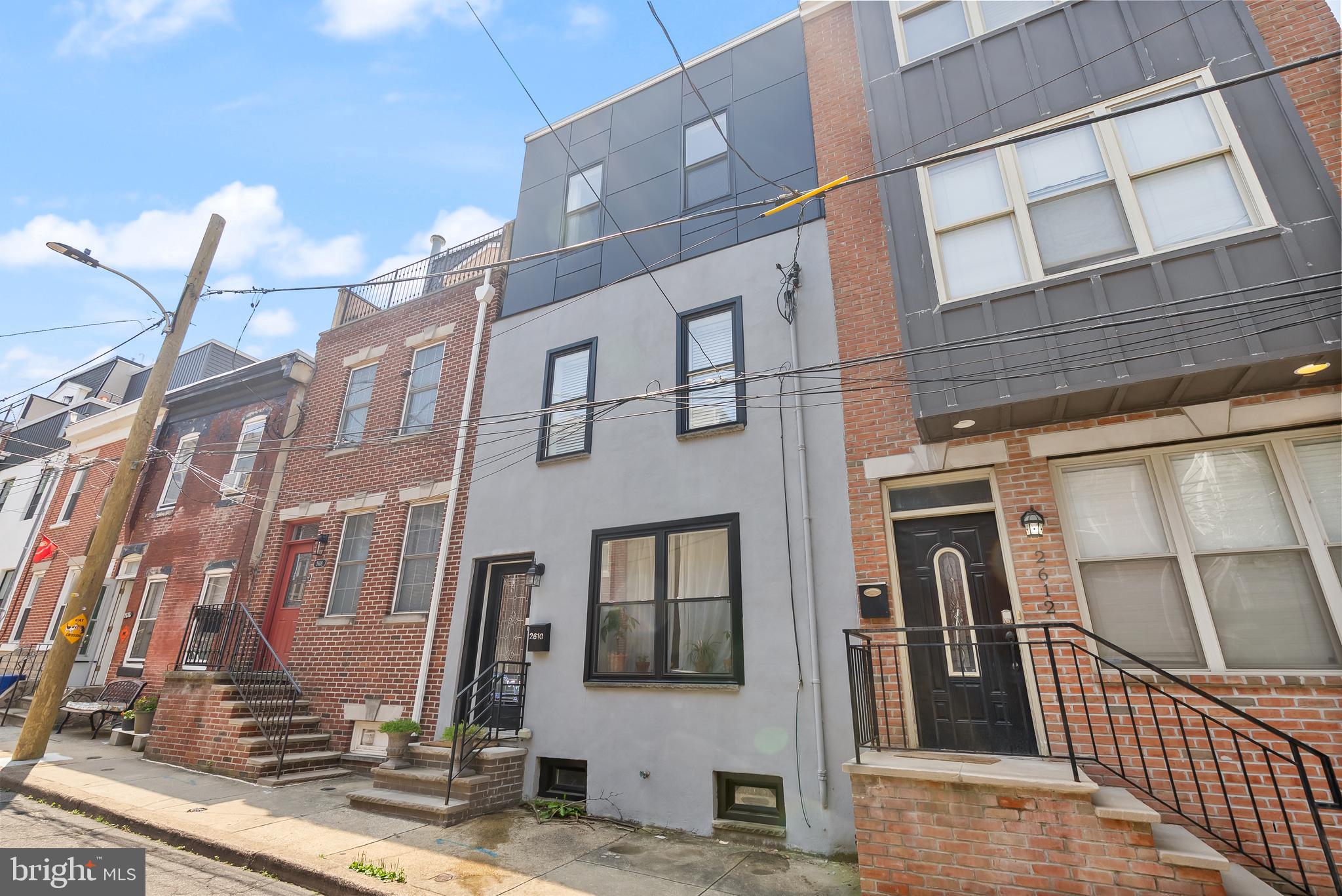 TAX ABATEMENT APPROVED THROUGH 2026! Wow! Welcome to 2610 Catharine Street...maybe your future home. A Beautiful Newer 3 Bedroom, 2 1/2 Bath Rehab with 3rd Story Addition and boasting 1,700 sq. ft. including the basement in Graduate Hospital. Conveniently located just minutes from the South Street Bridge, I-76, 1-95, major bridges, the airport, CHOP Roberts Center, University City including Drexel and Penn, Center City, and so much more. Located in sought after Chester A. Arthur Elementary School catchment. Live in the heart of it all! Upon walking up to the property you will find beautiful gray stucco and a modern/sleek metal dark gray exterior on the 3rd floor. Entering through the large metal door with long glass window, you will find a completely renovated and modern new home! Throughout the house, you will find beautiful 5" x 3/4" thick oak hardwood floors (except in the basement and bathrooms). The first floor boasts exposed brick walls and a nice-sized open floor plan with living room, dining room, and kitchen. The kitchen features granite countertops and plenty of cabinet space with soft close doors and drawers. The large granite island with stainless steel sink and garbage disposal is a great place for entertaining and seating. All stainless steel appliances including a LG French Door refrigerator with bottom freezer; LG gas range with hood; LG Dishwasher with QuadWash; and an LG Microwave. Gorgeous tile back splash! Tons of natural light on the first floor! Off of the dining room through the French doors is a perfect outdoor space with flower bed! The basement is partially finished with a powder room and all mechanical systems. Great for a recreation room! There is a small unfinished crawlspace in the rear of the basement and a source of egress that exits to the back yard. On the second floor, you will find 2 nice-sized bedrooms with good closet space and the front has a walk-in closet and ton of natural light. Good window space throughout this home! The laundry room has a Samsung High Efficiency Front Loading Washer with steam and a Samsung Gas Dryer with Steam. A beautiful 3-piece ceramic tile bathroom with tub/shower is also on this floor. Continuing on to the 3rd floor is the main Suite with walk-in closet and full Bathroom. There is an additional den/office with balcony overlooking the yard. Built-in with shelving and rods to hang clothing on both sides in walk-in closet. Beautiful main bath with double sink and a stunning tiled walk-in shower with glass door. The Main Suite is simply perfect. This place is beautiful! Come check it for yourself! Don't overlook this one...a unique home on a quiet side street. Available to close on September 1st 2025 due to existing lease.