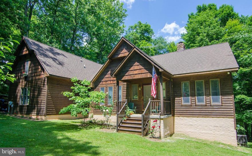 Rare opportunity to own a cedar contemporary with river access and a view!  Downhill access, but someone could put in steps and or, a switchback. This home offers 22ft. ceilings and a floor to ceiling stone fireplace (stones from the Potomac River). Open floor plan flows nicely to three bedrooms, two of which share a full bath but master suite has a large walk in closet and bath has double sinks, jacuzzi tub and large separate shower! Room for a first floor office as well. Beautiful wood floors throughout. You can see the river (winter view) through the trees from the kitchen, dining, great room and 2  bedrooms and, the deck and the screened porch!  A finished bonus room upstairs with a bath, offers another bedroom if desired or studio/office. The kitchen is central to the great room with an island and built-ins, and easy access to basement and garage.  Wooded lot offers plenty of firewood for the wood burning fireplace or wood furnace. Three sources of heat in the house include radiant floors, wood furnace and heat pump! Only 5 minutes from Shepherdstown, with easy access from there into Maryland and commuter routes. Steamboat Run Community offers a common area as well, to put in canoes or boats, and a picnic area. This one will not last for sure.