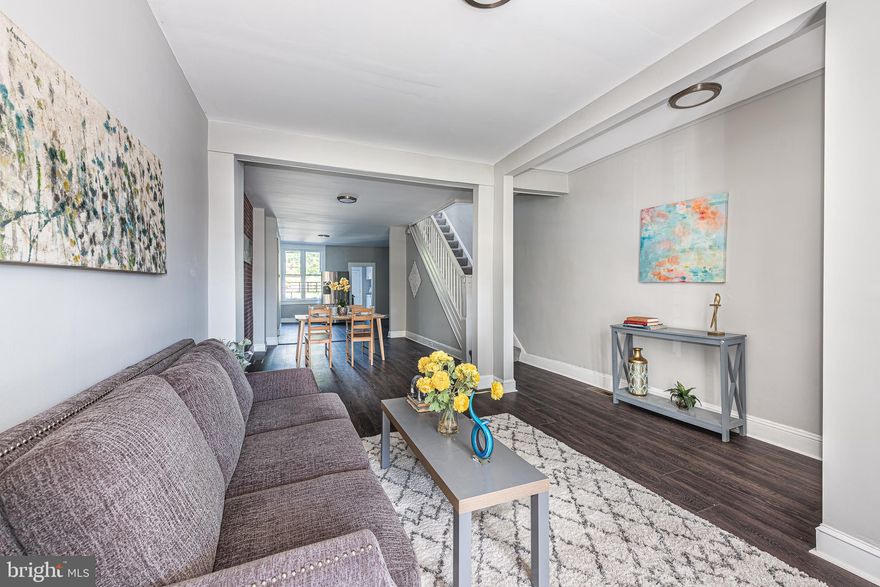 EXCELLENT OPPORTUNITY TO PURCHASE THIS PORCH FRONT ROWHOME AND ADD YOUR OWN PERSONAL TOUCHES!  Features include an open floor plan, wood floors throughout the main level, a spacious living room with a dining area, a bonus space that would be perfect for a breakfast room or den, galley kitchen with ss appliances & granite counters, upper level with 3 bedrooms and 1 full bath, basement with a family room, bedroom, and full bath, and a rear patio.  Basement needs some work but has great potential!  Sold As-Is!  Cash or 203k only!