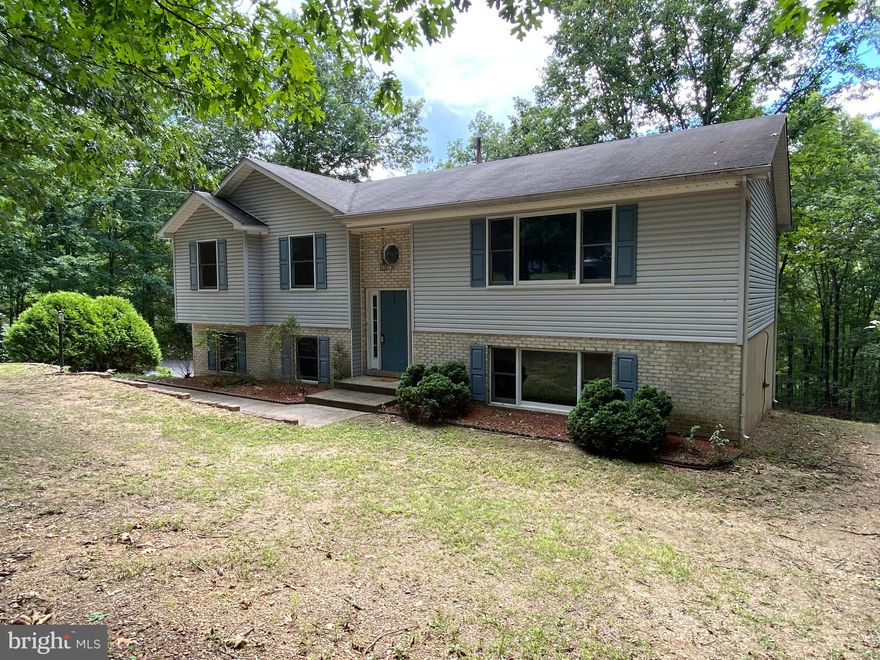 **HUGE PRICE ADJUSTMENT**  Popular 3 bedroom / 2-bathroom design offering plenty of space in the area's typically used the most!  Main level features include a large living room, fully equipped kitchen with breakfast bar, primary bedroom and bathroom, and access to the huge 2 level rear deck!  The lower level completes the picture with a massive family room, fireplace, laundry, and access to the spacious 2 car garage! Built in the heart of almost an acre and a half and fronting on a cul de sac, this house is a gem you don't find every day!  Don't wait, call for your appointment TODAY!!