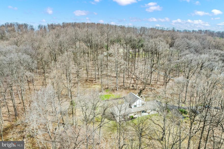 **Highest and best offer due by 3pm on Monday 10/16**  This beautiful, well maintained home is nestled on over 3 acres of land and offers both serene and private living at its finest.  The property has mature landscaping and 4 wheeling trails throughout.  First floor boasts not 1, but 2 large living room areas, one with exposed beams and sliding glass doors leading to the outdoor entertainment area, and the other with a bay window filling the room with natural lighting.   Open kitchen features an island, built in desk and all appliances included. Also conveniently located on the first floor is a full laundry room off the oversized 2 car garage, and a office that could be easily converted to bedroom.  2nd floor has 3 nice size bedrooms and 2 full bathrooms with a walk-in closet in the primary bedroom.  Full basement ready to be finished and backup generator hook available.