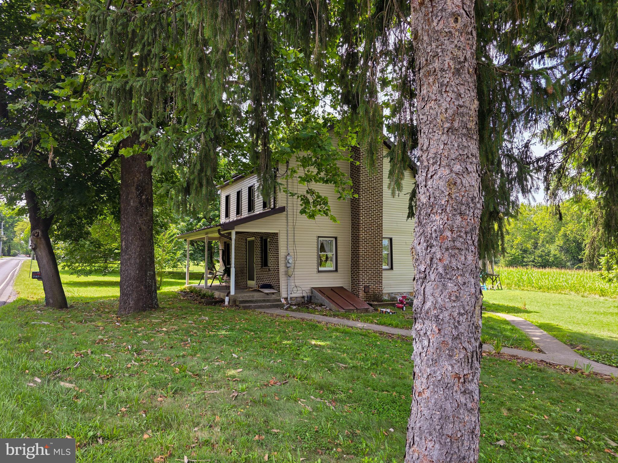 Step back in time and into comfort with this unique late-1800s home, nestled on 1.73 acres of homesteader’s paradise. Full of rustic character, the home features a striking stone accent wall in the family room and exposed hewn logs in the basement — original details that tell a story. The spacious backyard is graced by mature black walnut trees, adding both beauty and value. Along the south border, a stately row of sugar maples not only puts on a spectacular autumn show, but also offers the opportunity to tap your own maple syrup. Come summer, the established black raspberry patch yields bountiful fruit for your table, while the enriched garden soil is ready for your next planting season. Inside, enjoy the practicality of main-level laundry and a concrete-floored basement with solid shelving — perfect for storing your home-canned goods. Step outside to take in peaceful views of open fields and woodland, where white-tail deer graze and Canada geese raise their young in the spring. A detached garage offers one-car parking with a spacious loft above. Updates made around 2012 include a durable steel roof and a smooth, crack-free concrete floor. Best of all, nature lovers will be thrilled to find the entrance to King’s Gap Environmental Education Center directly across the road. Explore miles of scenic hiking trails, or visit the historic Cameron Mansion and Education Building for a dose of local heritage.
If you're seeking country tranquility, historic charm, and the perfect setting for a self-sufficient lifestyle — this property has it all - even an enchanting train whistle that echoes across the valley each day.