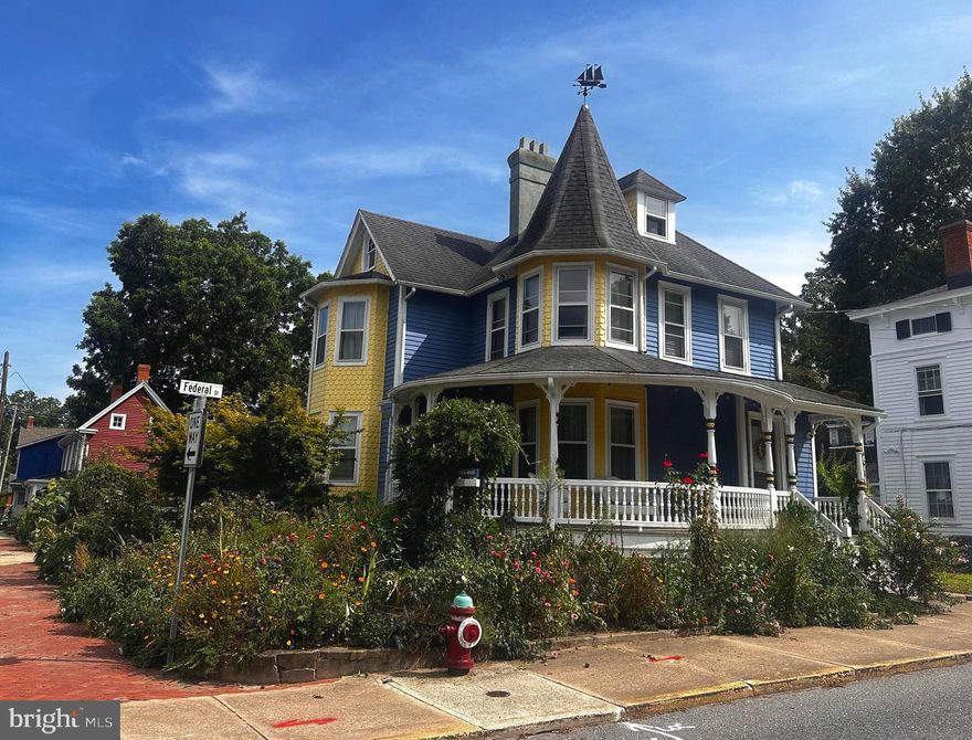 Old world grandeur with small town charm!

Step into timeless elegance with this beautifully maintained and thoughtfully restored Queen Anne Revival Style Victorian, built in 1903 and ideally located in the heart of Downtown Milton. Rich in character yet seamlessly updated for modern living, this exceptional home offers four spacious bedrooms, including a large finished attic and three-and-a-half baths, providing both comfort and flexibility for everyday living and entertaining.

At the heart of the home is a true chef’s kitchen, anchored by a rare and iconic AGA cast-iron range—a coveted British-designed stove renowned for radiant heat cooking that locks in moisture and flavor. Prized by serious home chefs and seldom found in the United States, this premium range elevates the kitchen into a culinary showpiece. Paired with an inviting eat-in area, the space is as functional as it is inspiring, perfect for gatherings both casual and elegant.

Throughout the home, original charm shines with hardwood flooring, decorative fireplaces, and light-filled rooms that reflect the craftsmanship of a bygone era. A full basement with impressive ceiling height (approximately 8–9 feet) offers an exceptional amount of storage or future potential—an uncommon and highly desirable feature in a home of this age. A new water heater (2025) adds peace of mind.

Outside, the property truly enchants. Set on a corner lot, the home is surrounded by lush, meticulously maintained gardens with automatic irrigation and inviting outdoor spaces, including a wrap-around porch and patio—ideal for morning coffee, evening conversations, or simply enjoying the beauty of the seasons. Parking is conveniently available via the side driveway along Federal Street, offering off-street parking in a prime downtown setting.

Just steps from local restaurants, shops, and community events, this remarkable Victorian blends historic charm, modern functionality, and an unbeatable location. A rare opportunity to own a lovingly restored piece of Milton’s history—where elegance, craftsmanship, and lifestyle come together beautifully.