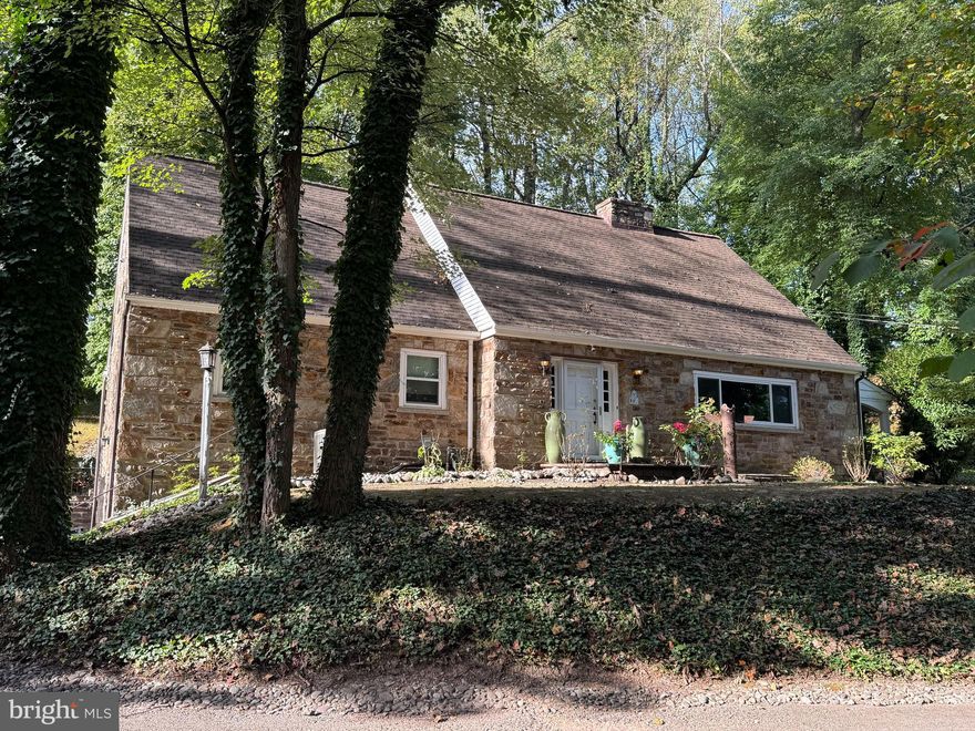 A unique combination of charm and modern convenience make this lovely cape cod home an outstanding value in a private, but central location just seconds from the Gulph Mills interchange on Route 76. Located at the end of a private driveway to 3 homes off S Gulph Rd., this 4 bedroom, 3.5 bath home features a custom built 3 stop elevator from the attached 2 car garage to the bedroom hallway on the main floor and then up to the primary bedroom suite on the upper floor. Other upgrades include a country kitchen with stainless appliances, three fireplaces, remodeled full bathrooms, central A/C and a whole house generator. The custom designed primary suite has multiple closets, luxurious bath with large shower stall, skylight and custom vanity, raised ceiling with accent lighting in soffit, gas fireplace and built-in desk. Second top floor bedroom has its own ensuite bath, closet with built-in shelving and a walk-in closet/storage room with access to additional eave storage. Main level features kitchen with access to stone rear patio; a formal dining room with access to covered side porch, large bright great room with lovely stone fireplace and built-in cabinets and 2 bedrooms that share a hallway bath with shower over stall. Lower level has large office with fireplace and built-in cabinetry, large laundry/storage room, powder room and access to the 2 car garage. The exterior features multiple outdoor areas including a covered side porch and a full length rear patio which looks to a wooded rear lot featuring stairway and path to an original log cabin currently used for storage. This unique and special property is an outstanding value!