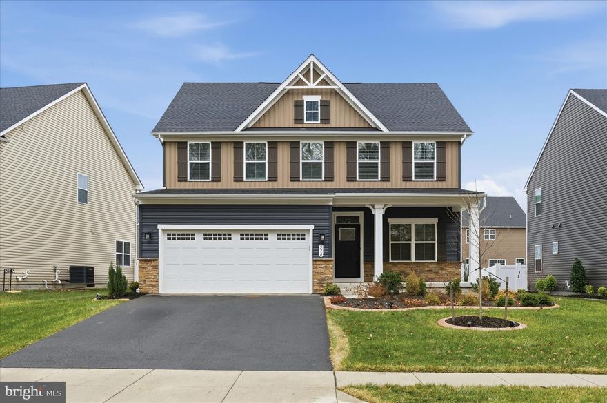 MOVE IN READY JUST BRING YOUR FURNITURE! This home has it all!  Don’t wait for new construction when this like-new home is ready for immediate occupancy! Located in the desirable Lakes at Martinsburg community, this beautifully maintained home offers three fully finished levels and an open floor plan ideal for today’s lifestyle. The gourmet kitchen boasts 2 ovens, built in microwave, tons of cabinet space, large island plus dining area. Family room open to kitchen and dining. Formal living room or could make an office at the entry. Enjoy a welcoming front porch overlooking peaceful woods, perfect for relaxing mornings or evenings. Main level have LVP floors. All bedrooms are generously sized, including a spacious primary suite with a walk-in closet and large private bath. Convenient upstairs laundry adds everyday ease. Enjoy the private fenced back yard from your maintenance free deck. HOUSE BONUSES: Tesla charger, Peloton Bike.
 The community features a lake, jogging and walking trails, dog park, and tot lot, offering something for everyone. Move-in ready and waiting for you to call it home!