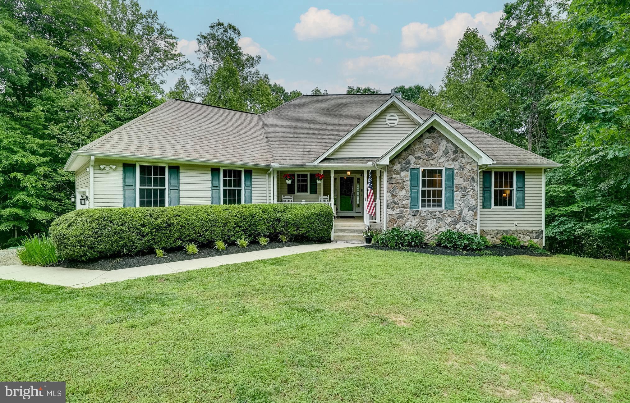 Upgrade your lifestyle with this beautiful lake access retreat at Lake Anna, Virginia, with seasonal water views, high speed Comcast Xfinity internet, boat slips to lease, basketball and tennis courts, and other amenities galore - all within the coveted Wyndemere subdivision on the public side of Lake Anna. Offering over 3,100+ finished square feet spread out over two levels, with 5 bedrooms and 3.5 baths. The main floor features a family room with vaulted ceilings and a gas fireplace, all of which, seamlessly connect with the breakfast room and spacious kitchen that provides black stainless appliances and tile flooring. There is also a spacious primary bedroom, conveniently located on the main level and includes a walk-in closet and en suite bathroom. Two additional bedrooms, a full bath, and half bath complete the main level. Your family and guests will love the newly finished walkout basement that provides a second family room, recreation/game area, two additional bedrooms, laundry, a full bath and storage room! Step outside to the massive multi-level decks where you will enjoy relaxing and sipping your morning coffee or evening cocktails, all while taking in the natural wildlife. This home also has a path down to the waterfront common area for added convenience and fun! Wyndemere offers three common areas where you'll enjoy basketball, tennis, a boat ramp and boat slips are available for lease on a yearly basis. Golf cart friendly community! Incredible central location on Lake Anna; close to groceries, restaurants, ABC and more. This home has many recent improvements in the last few years to include the newly finished basement, all new electrical in kitchen and new gutter guards!