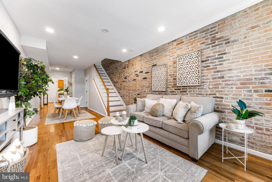 Location, location location! This charming turnkey Locust Point townhome welcomes you in with exposed brick wall accents and beautiful hard wood flooring. The kitchen has custom cabinets, stainless steel appliances, and plenty of counter space! The second floor showcases the primary with ample closet space and a second bedroom with deck access. The basement level has a finished den space. Conveniently located near Baltimore water taxi, Ft McHenry, Under Armour facility, and endless shops and restaurants. Welcome Home