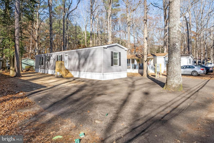 Be the first to live in this just-delivered 2026 model manufactured home, thoughtfully placed on its site and ready for immediate enjoyment. This spacious 3-bedroom, 2-bathroom residence offers modern comforts, stylish finishes, and an inviting open layout. Step through the front door into a bright living room featuring luxury vinyl plank flooring, seamlessly connected to the open kitchen. The kitchen is designed for both beauty and function with stainless steel appliances, including a gas range and stove, built-in microwave, double sinks, and ample counter space—perfect for everyday cooking or entertaining.
The primary bedroom provides a peaceful retreat with its own ensuite bathroom, complete with a step-in shower with built-in bench for added comfort. Two additional guest bedrooms share a well-appointed full bathroom with a tub/shower combo. This home also boasts a high-efficiency propane furnace and a high-SEER air conditioning system, ensuring year-round comfort with lower energy costs. Located in the desirable community of Shawn’s Hideaway, you’ll be just steps from Burton’s Prong, which leads directly to the Rehoboth Bay—perfect for those who love nature and water recreation. Residents enjoy access to boat slips (currently on a wait list). Best of all, ground rent is only $500 per month—a fantastic value for this coastal setting. Move-in ready, modern, and minutes from the water—don’t miss this rare opportunity!