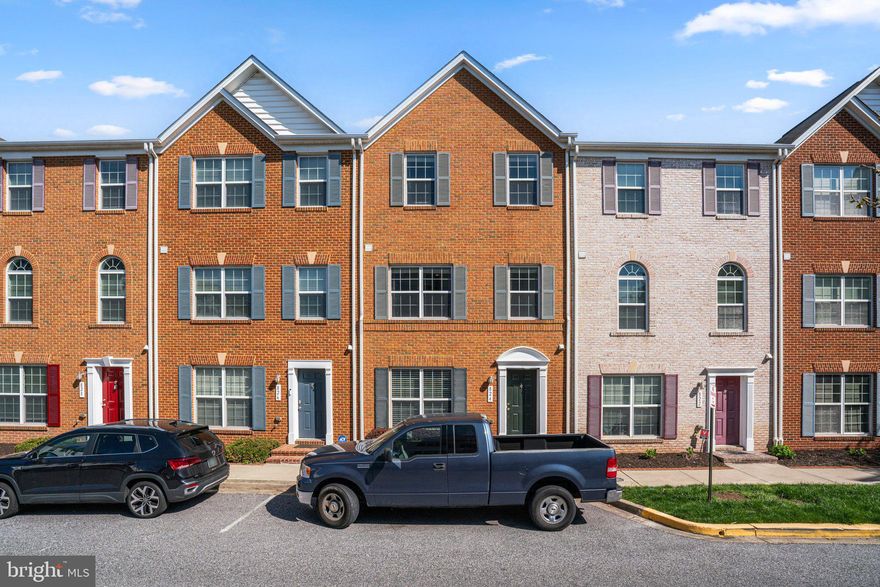 Lovely freshly painted 4BR 3.5BA townhome in Camden Crossing was built in 2010 and has a 2 car garage and parking pad. Main level Living/dining room and first level bedroom have hardwood flooring. Eat-in kitchen has ceramic tile flooring, stainless steel appliances, gas stove, granite countertops and breakfast bar.  Main level also includes washer/ dryer, half bath and patio off of living room. Three carpeted bedrooms on upper level. Spacious primary bedroom suite has vaulted ceiling, walk-in closet and bathroom with double vanity, soaking tub and separate shower. Additional full baths off upper level hallway and in first level bedroom suite. Great location. Close to stadiums, restaurants, bars, UMD, Inner Harbor and I-95. Must see!!!