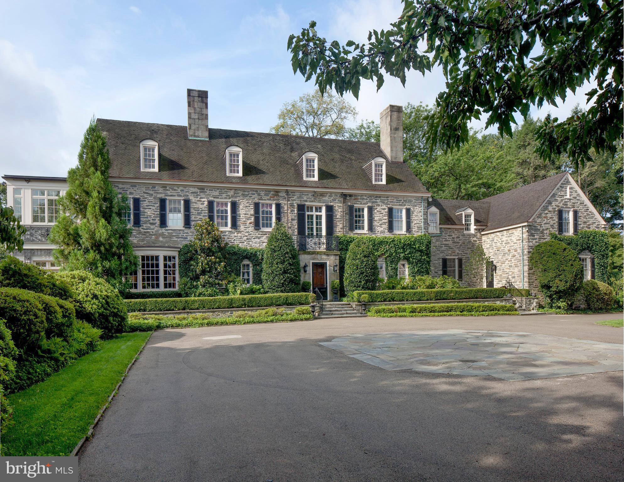 For the Family at the Pinnacle of Success Fenimore, one of the last of the great Main Line estates, has been converted to the lifestyle of today. Set on 5.89 acres with additional surrounding conserved ground, this magnificent stone house has a Ludowici tile roof. There is a separate six-car garage with an apartment, a pool and numerous stone walks and terraces. The plantings are in a wonderful mature state. The interior, with 6 bedrooms, 7 baths (two in the master suite) and 2 powder rooms has been imaginatively updated to include every expected modern amenity. This remodeling was sensitively carried out to complement the elegant original details of the house. This is an indoor-outdoor house with French doors throughout. It lends itself to intimate family activity as well as gracious large-scale entertaining. Monogram the towels and move in!