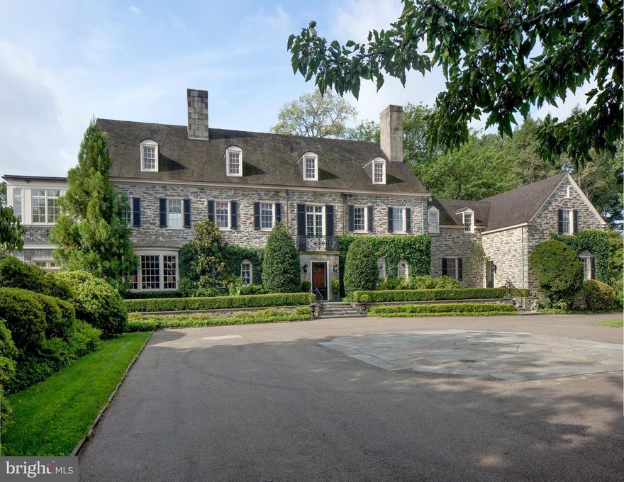 For the Family at the Pinnacle of Success  Fenimore, one of the last of the great Main Line estates, has been converted to the lifestyle of today. Set on 5.89 acres with additional surrounding conserved ground, this magnificent stone house has a Ludowici tile roof. There is a separate six-car garage with an apartment, a pool and numerous stone walks and terraces. The plantings are in a wonderful mature state. The interior, with 6 bedrooms, 7 baths (two in the master suite) and 2 powder rooms has been imaginatively updated to include every expected modern amenity. This remodeling was sensitively carried out to complement the elegant original details of the house. This is an indoor-outdoor house with French doors throughout. It lends itself to intimate family activity as well as gracious large-scale entertaining. Monogram the towels and move in!