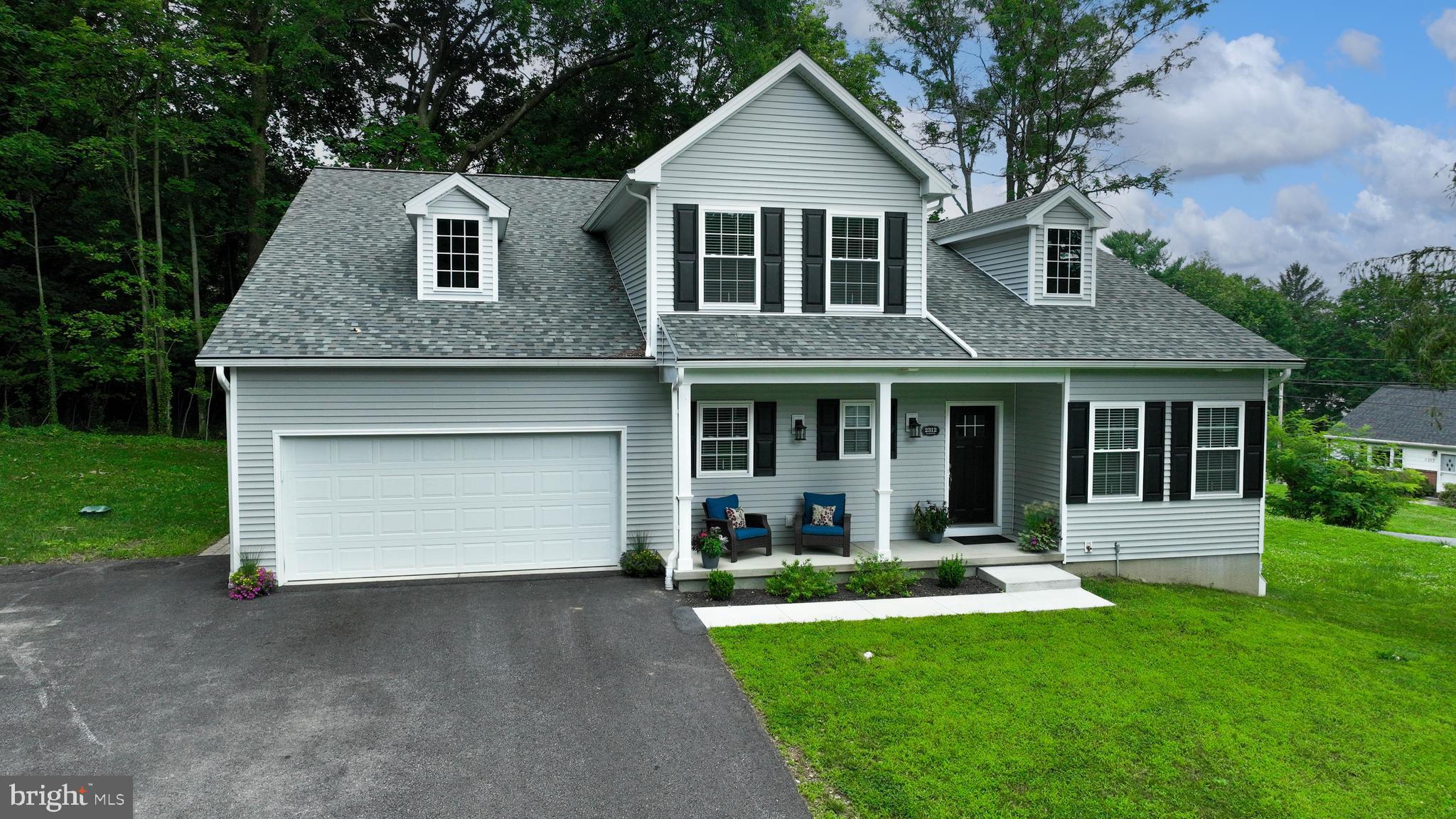 Welcome to 2312 Raleigh Drive, a beautifully crafted home set on a quiet, wooded corner lot in the Blossom Hill neighborhood of Manheim Township. Built just two years ago by Jon Warner Homes, this custom four-bedroom residence boasts comfort, flexibility, and thoughtful design throughout. Inside, you’ll find a first-floor primary suite for easy living, as well as a second bedroom on the main level with its own private bath, perfect for guests or family. Upstairs, two more bedrooms share an adjacent full bath, along with a versatile den or office, and a spacious rec room that can also serve as a fifth bedroom. The lower level, constructed with Superior Walls, is ready for your finishing touches. It’s already plumbed for a full bath and provides potential for a rec room and additional bedroom, while still providing ample storage space. Throughout the main floor, nine-foot ceilings enhance the sense of openness. The living room is highlighted by a cozy gas fireplace. The kitchen and dining area are designed for both function and style, featuring a large walk-in butler’s pantry with abundant storage space for food, kitchen essentials, and even the possibility of a portable coffee station. Just off the dining area, a screened porch offers a peaceful retreat for relaxing and opens to a paver patio. The oversized garage adds to the home's practicality, with extra space for storage cabinets and a convenient bump-out ideal for yard tools or equipment. You'll also appreciate the extended driveway, offering plenty of extra parking space. Located in the heart of Manheim Township, this home combines tranquility with accessibility to everything you need. Move-in ready and waiting for its next chapter, this home invites you to schedule a private tour today.