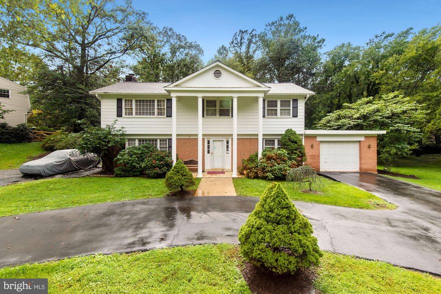 Stately home with circular driveway on large .66 acre treed lot in prestigious Oakton.  You will be hard pressed to find a detached home for this price in this location.  Main/entry-level features large bedroom and full bath that could be used as in law suite.  Huge family room with brick fireplace.  Home boasts hardwood flooring, crown and chair rail molding, ceramic tile.  Roof replaced 3 years ago.  Furnace and A/C replaced 4 - 5 years ago.  New water heater.  Large deck overlooking expansive, partially fenced treed rear yard.  Large patio with outdoor fireplace.  Gas cooking.  Hot water baseboard heat.  Use your imagination for any additional desired updates.  Years of love have been invested in this home in one of the finest communities in Oakton,  convenient to Reston, Fair Oaks and Vienna.  This is a real gem for the creative with location paramount.