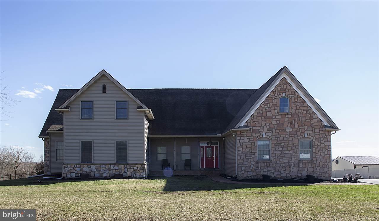Country lovers dream!  Beautiful open floor plan nestled on a quiet street with a scenic view or rolling farm fields behind you.  An abundance of space to finish if you choose in the lower level.  If you have been needing extra space to work on cars or storage enjoy the over sized additional detached garage.  With summer right around the corner enjoy evening cookouts on the sprawling deck while entertaining.  Many wonderful features and upgrades.  A very unique find!