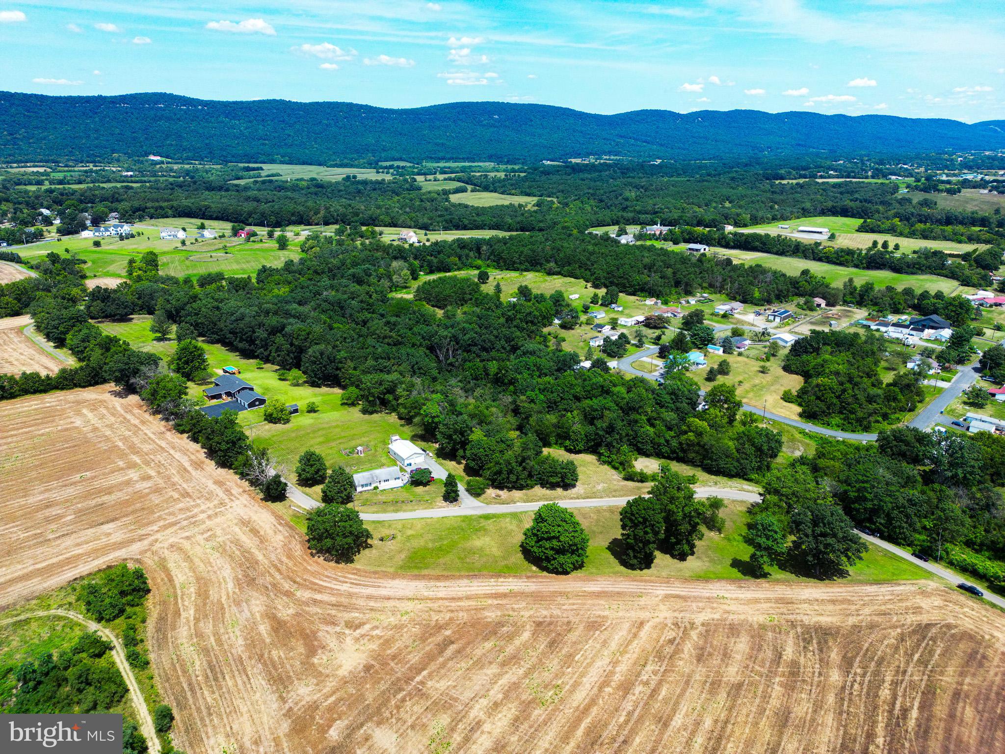 OPEN HOUSE 8/3 AND 8/10 2PM TO 4PM***HORSE LOVERS/OUTDOOR ENTHUSIASTS DELIGHT***NEW BUILD***RARE FIND*** 4 Bedrooms, 3 and a half bathrooms, oversized 3 car garage, 11.65 acres, 3 stall horse barn with additional storage. Rustic feel home with all brand new amenities. Inviting 24X8 covered front porch enters into large living room with vaulted white washed knotty pine ceilings, natural hardwood floors and pellet stove. Living room opens into chefs choice eat in kitchen with large island, butcher block counters, custom "soft close" walnut cabinets, stainless steel appliances, and pot filler over the stove. French double doors on the rear of the kitchen lead to 27X14 covered rear deck complete with included table and chairs, 3 ceiling fans, additional room for lounging, and serene, private wooded views. 2 of the main level bedrooms have full bathrooms attached, including a jacuzzi tub and low threshold walk in shower in the primary suite. Large full guest bath with double vanity on main level. Office/Nursery/5th Small Bedroom and separate laundry facility on the main level. Fully finished basement boasts 14X14 bedroom with large walk in closet and adjoining sitting room and half bath. Basement Game/Family room measures 22X17. Above ground pool, tastefully surrounded by custom paneling on 3 sides and 4th side allows access by gate to stairs to the pool deck. Electric fenced area in the rear of the property for horses or livestock. Oversized heated 3 car detached garage is insulated, drywalled, has newly coated resin floors, all new doors and openers. Stunning views, quiet and private living that is still close to all amenities. Easy access to highways and turnpike, makes for relaxed country living with an easy commute to all nearby cities. ***PROFESSIONAL PHOTOS FORTCHOMING BY SATURDAY***HANDMADE LIVE EDGE SYCAMORE KITCHEN TABLE AND CHAIRS IS FOR SALE..$2000***