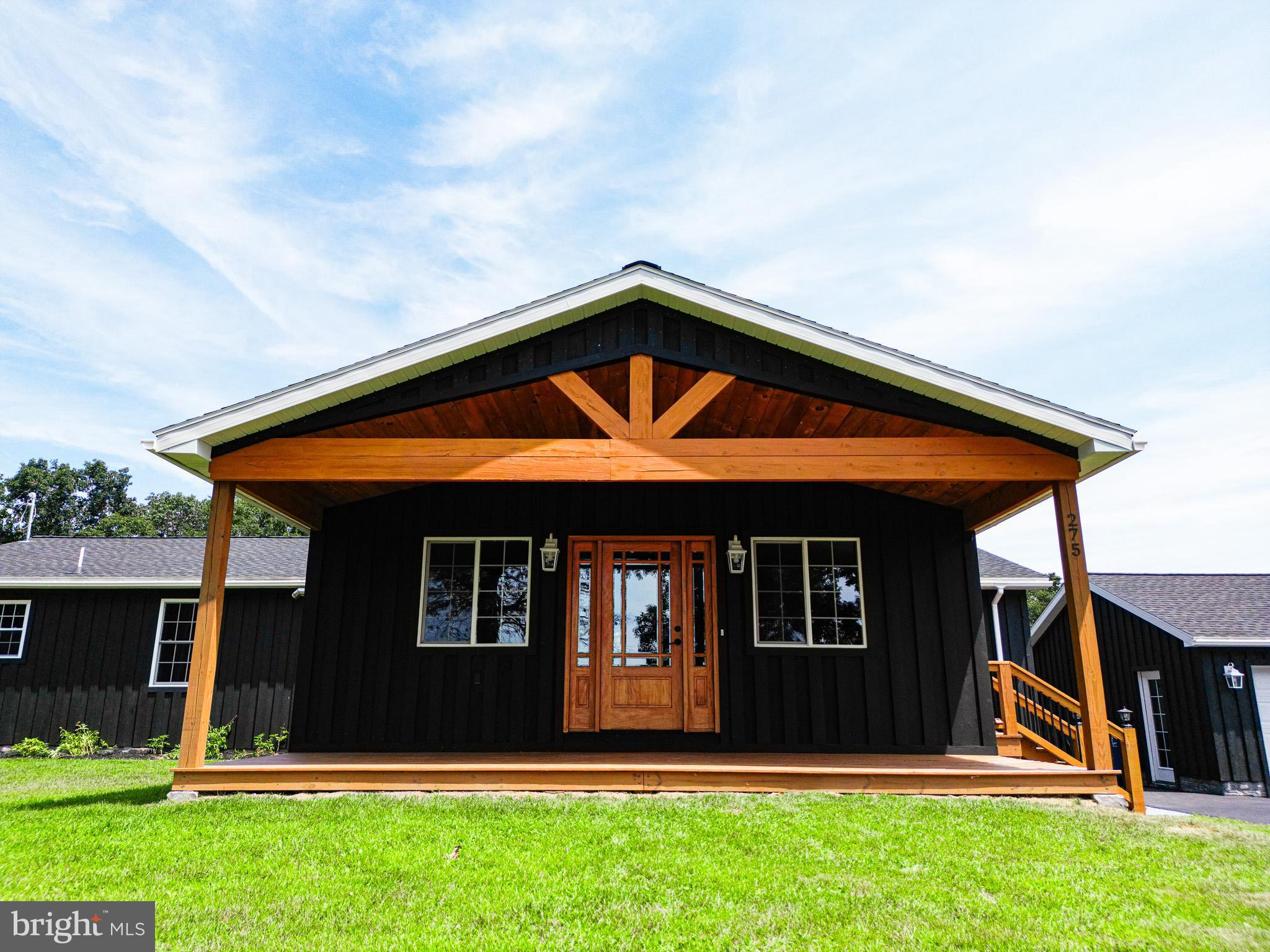 ***HORSE LOVERS/OUTDOOR ENTHUSIASTS DELIGHT***NEW BUILD***RARE FIND***CLEAN AND GREEN*** 4 Bedrooms, 3 and a half bathrooms, oversized 3 car garage, 11.65 acres, 3 stall horse barn with additional storage, new saline pool. Rustic feel home with all brand new amenities. Inviting 24X8 covered front porch enters into large living room with vaulted white washed knotty pine ceilings, natural hardwood floors and pellet stove. Living room opens into chefs choice eat in kitchen with large island, butcher block counters, custom "soft close" walnut cabinets, stainless steel appliances, and pot filler over the stove. French double doors on the rear of the kitchen lead to 27X14 covered rear deck complete with included table and chairs, 3 ceiling fans, additional room for lounging, and serene, private wooded views. 2 of the main level bedrooms have full bathrooms attached, including a jacuzzi tub and low threshold walk in shower in the primary suite. Large full guest bath with double vanity on main level. Office/Nursery/5th Small Bedroom and separate laundry facility on the main level. Fully finished basement boasts 14X14 bedroom with large walk in closet and adjoining sitting room and half bath. Basement Game/Family room measures 22X17. Above ground pool, tastefully surrounded by custom paneling on 3 sides and 4th side allows access by gate to stairs to the pool deck. Electric fenced area in the rear of the property for horses or livestock. Oversized heated 3 car detached garage is insulated, drywalled, has newly coated resin floors, all new doors and openers. Stunning views, quiet and private living that is still close to all amenities. Easy access to highways and turnpike, makes for relaxed country living with an easy commute to all nearby cities.***HANDMADE LIVE EDGE SYCAMORE KITCHEN TABLE AND CHAIRS IS FOR SALE..$2000***