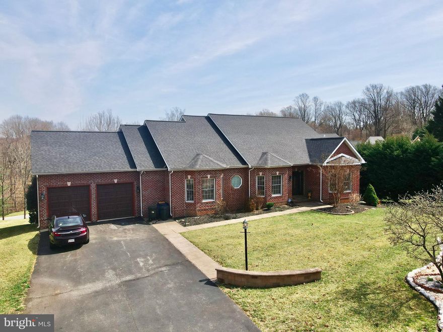 Nestled on a private cul-de-sac in one of Ellicott City's most desirable neighborhoods, this elegant brick-front rancher offers an exquisite blend of timeless charm and modern comfort. Boasting over 4,000 square feet of thoughtfully designed living space, this home welcomes you with an open-concept layout, seamlessly connecting the living room, family room, and formal dining area. The chef’s kitchen is a culinary delight, featuring a built-in countertop range, double wall oven, dishwasher, and refrigerator—perfect for both everyday living and entertaining. The private primary suite is a true retreat, offering direct walk-out access to the expansive rear deck, dual walk-in closets, and a spa-like bath complete with a soaking tub, walk-in shower, and double vanity. Two additional generously sized bedrooms, a full bath, and a powder room complete the main level. A conveniently located mudroom with laundry connects directly to the oversized two-car garage for effortless functionality. The lower level extends the living space with a versatile layout, featuring a spacious bedroom, a potential second bedroom or home office with custom built-ins, a full bath, and an entertainment area with a built-in bar—ideal for hosting gatherings. Ample storage is provided by multiple storage rooms with built-in shelving. Step outside to the large rear deck, perfect for enjoying morning coffee or evening relaxation. Situated on a quiet cul-de-sac, this home offers privacy and tranquility while being just moments from Routes 29 and 70 for easy commuting. Don’t miss the opportunity to own this stunning residence in an exceptional location! Recent updates: Roof 2022, Hot water heater 2023, Garage doors 2024