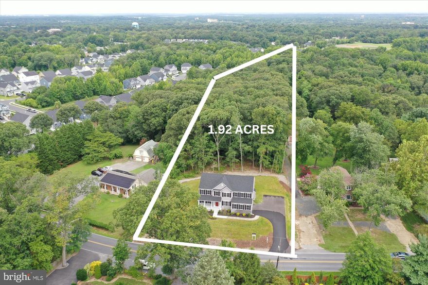 Home is now 100% complete. It's 3,100 finished sq. ft. includes 4 bedroom, 2.5 baths and lots of open living space. Rear wooded privacy on this 1.92 acre site. The open floorplan includes 9' ceilings and 7" luxury vinyl plank flooring throughout the main level, 2nd floor stairs and upper hallway. Also included  are the first floor office/library and family room with gas log fireplace opening to the kitchen and sunroom. The gourmet kitchen includes gas cooktop, under counter microwave, 2 wall ovens, 42" Maple raised panel soft close cabinets, island breakfast bar, granite counter tops & stainless appliances...all well lit with ample recessed and pendant lighting. The primary bedroom suite includes his/her walk in closets and a spa inspired bath featuring the frameless glass shower enclosure and soothing soak tub. All secondary bedrooms  have walk in closets and ceiling fan rough-ins. Living room, family room & sunroom also have ceiling fan rough-ins.  Mechanicals include the 14 SEER heat pumps (2 zones) and 400 amp electric service...plenty of juice for an optional home vehicle charging station in the side load 2 car garage. Options are endless in the full unfinished walkout basement with full sized windows and roughed in bath...imagine additional bedroom & bath, home gym, theater, rec/game room or sports bar and entertainment center. Buyer responsible for contracting with propane provider.