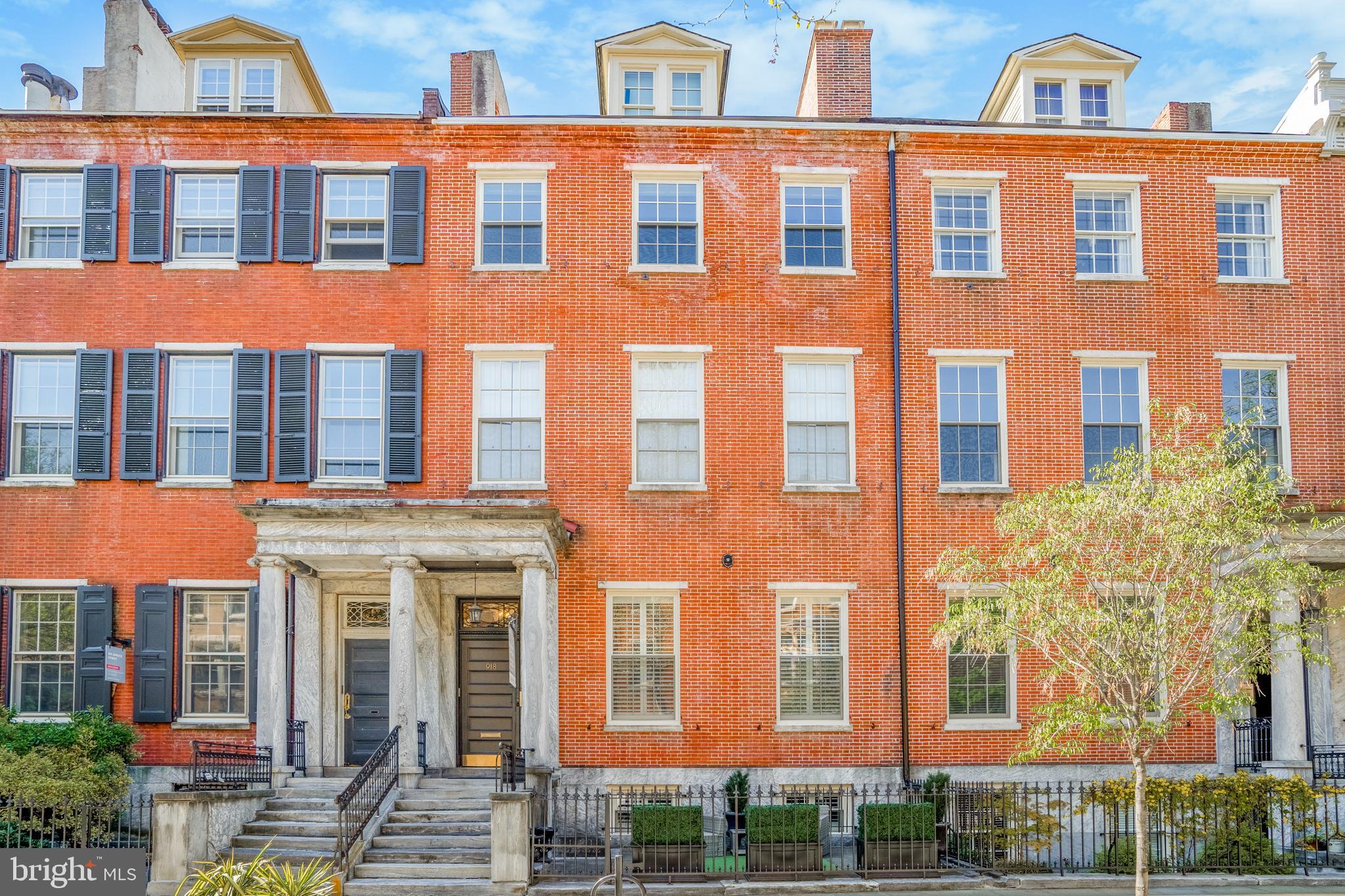 Spacious, light-filled 1 bedroom PLUS den/office located in historic Portico Row building in the heart of Washington Square West! This beautiful condo has character and cool architectural details as well as modern amenities. 10' ceilings plus a wall of windows that runs the length of the unit and maple hardwood floors throughout make this space feel bright and open. Enter into living/dining room which features wood-burning fireplace with brick facade, built-in book shelves and a pass through with breakfast bar to the kitchen. Great layout for easy entertaining. Kitchen has granite countertops, built-in microwave, tons of cabinetry, built-in wine rack and washer/dryer closet. Bonus room is perfect as a den or office space. French doors lead to large bedroom with south and west facing windows. Huge, walk-in closet as well as large hall closet means this unit does not lack storage space. Modern bath with beadboard and pedestal sink. This perfect Wash West location is convenient to hospitals, schools, restaurants and more! Do not miss this fabulous move-in ready condo with low fees and a gorgeous common garden courtyard! Condo is pet-friendly.