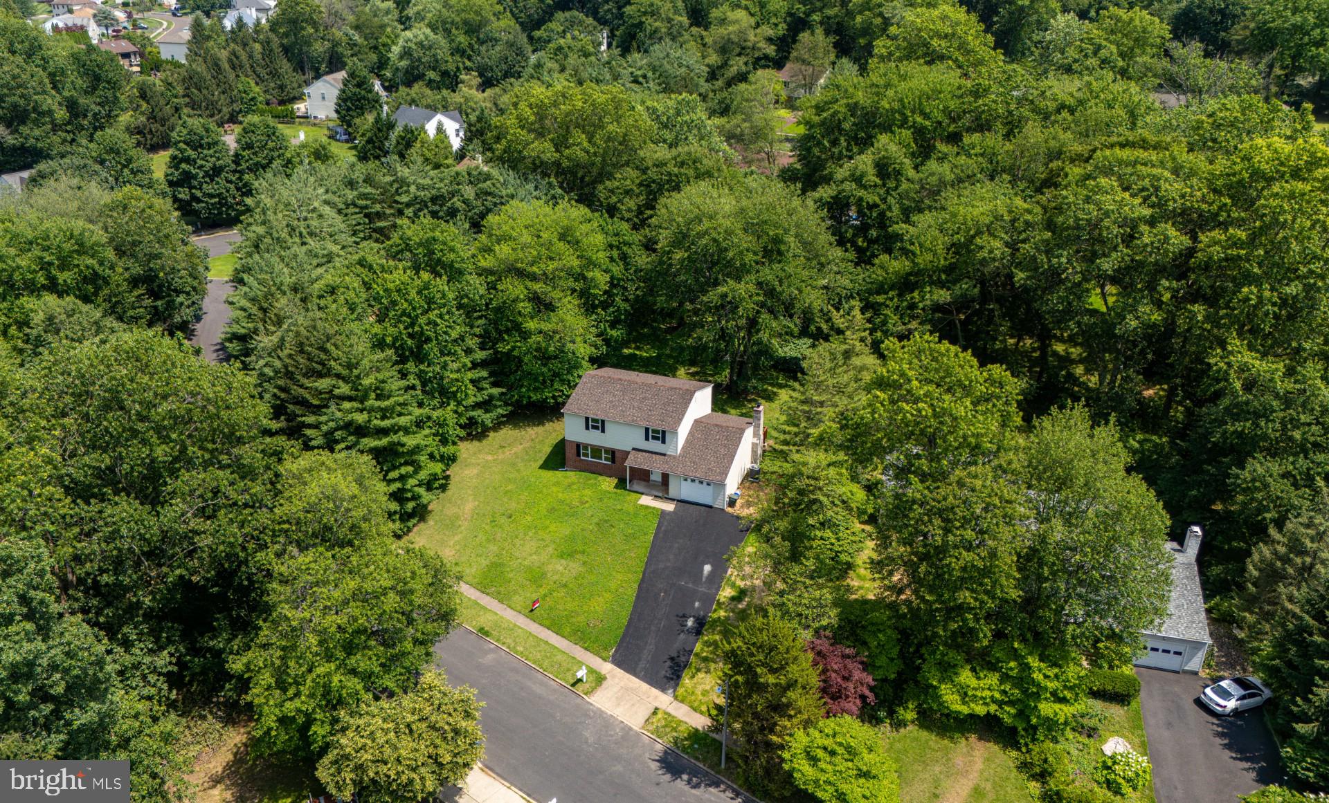 Nestled on a private half-acre lot at the end of a peaceful private (no through traffic) street, this stunning fully remodeled and MOVE-IN ready colonial-style single home offers a rare combination of space, style, and serenity. Backing up to tranquil views, this home is truly a personal retreat in one of Southampton’s most desirable neighborhoods. Professionally designed landscaping provides exceptional curb appeal for the new homeowners to enjoy. The home is located in walking distance to a well-known and popular multi-use Newtown Rail Trail in Upper Southampton Township. Step inside to find a spacious layout featuring a large living room and a formal dining room that flows seamlessly into a modern, well-appointed kitchen—complete with a beautiful island, brand new stainless steel appliances, ample cabinetry, and a dedicated breakfast area. The kitchen opens to a stunning family room with a granite-accented wood-burning fireplace perfect for cozy gatherings and access to the backyard and refinished deck through brand-new sliding doors. This 4-bedroom, 2.5-bath home includes a generous primary suite and a host of updates and amenities, including: spacious garage with inside access, nearly all new windows and doors, central air and an efficient electric heat pump, new water heater, roof, and driveway, refinished deck ideal for outdoor relaxation. Enjoy the ultimate in privacy and tranquility with peaceful backyard views, ideal for unwinding or entertaining. This home offers everything you need to live comfortably and stylishly in a prime location.