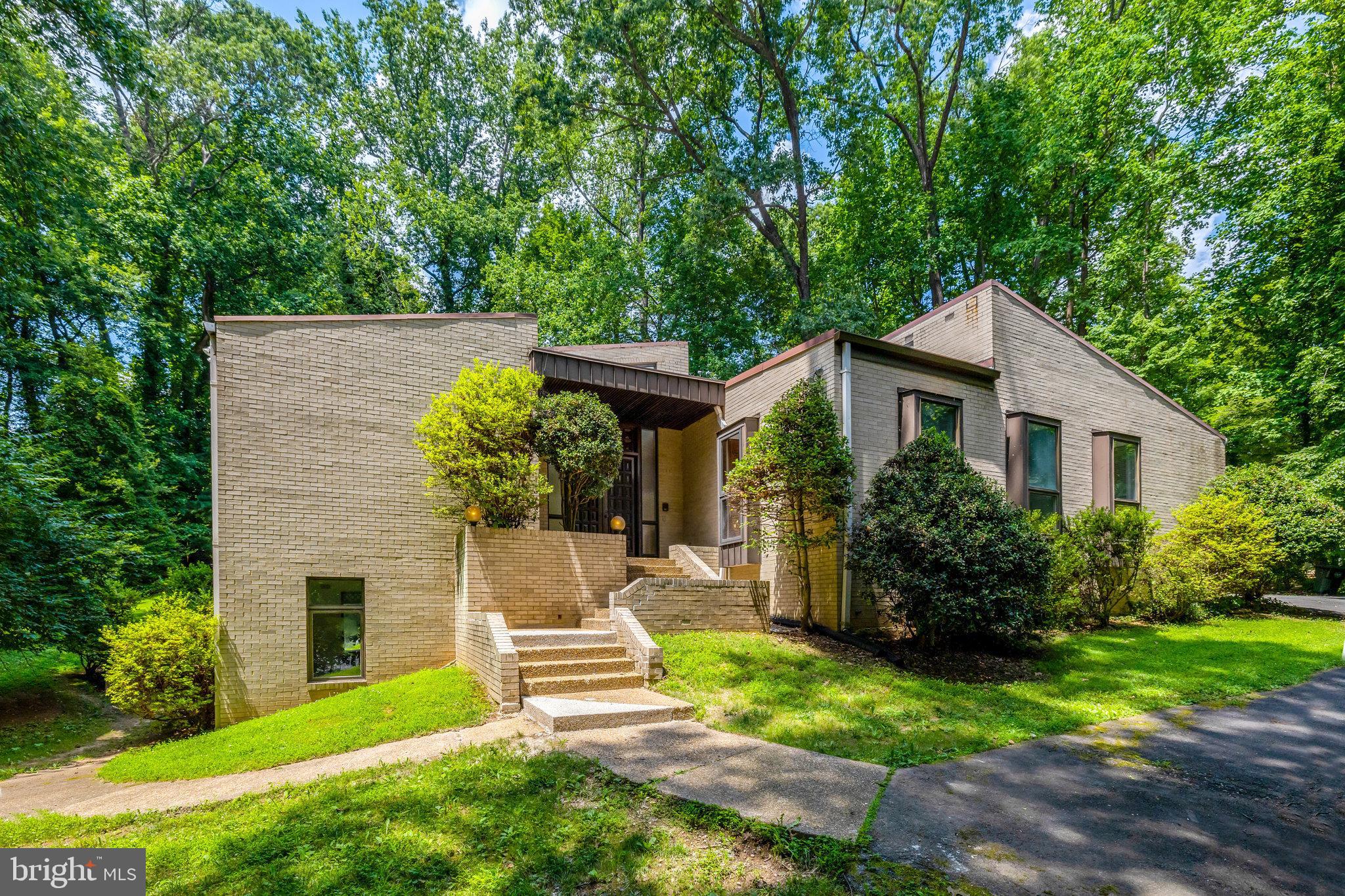 Custom-Built All-Brick Contemporary Estate in the Heart of Mantua – Over 5,000 Total Finished SQFT on 1.28 Acres. Located at the end of a quiet cul-de-sac in the prestigious Mantua community, this unique opportunity offers a residence with architectural distinction, grand scale, and timeless quality on a private 1.28-acre lot. With 5 bedrooms, 3.5 bathrooms, and over 5,000 total square feet of finished living space, this expansive home provides elegance, comfort, and the possibility for customization.
This estate property is being sold strictly As Is—a unique chance to transform and renovate a solidly built home in one of Fairfax County’s most sought-after neighborhoods.
A magnificent foyer sets a dramatic tone upon entry, leading into the main level where stunning vaulted and cathedral ceilings soar throughout. The living room boasts an impressive 15-foot ceiling, creating a light-filled, open environment perfect for both entertaining and everyday living. Refinished hardwood floors add warmth and sophistication throughout the main level.
Limited mobility access from the three-car front-loading garage directly into the main level enhances the home's functionality—ideal for multigenerational households or those seeking single-level living convenience.
The Main-Level Highlights includes a grand two-story foyer with abundant natural light and vaulted ceilings throughout main living areas. Open living and dining spaces ideal for entertaining as well as a spacious kitchen ready for customization. Primary suite and 2 additional bedrooms all on the main level
Main-level laundry room and interior access from garage off kitchen. Expansive Lower Level Includes a large family room with fireplace, game/media room perfect for a home theater, billiards, or recreation. Two additional bedrooms and a full bath on this level. Multiple storage areas and utility spaces
Additional Features : Three-car front-load garage. No HOA. Enjoy access to wooded trails, local parks, and the option to join the Mantua Swim and Tennis Club (rent first while waiting to purchase a membership). The active Mantua Citizens’ Association offers year-round social events and fosters a close-knit neighborhood atmosphere. This home is Commuter-Friendly & Convenient to Mantua Elementary that is only 3 blocks away. Easy access to I-495, Route 50, Route 29, I-395, and I-66, minutes to Vienna and Dunn Loring Metro stations, Mosaic District, and INOVA Fairfax Hospital. Less than one mile to Trader Joe’s and Pickett Shopping Center. Open Sunday July 13, 2-4 pm