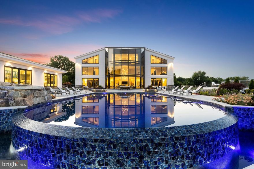 Truly a magnificent work of art.  This stunning one-of-a-kind estate is situated on a private, gated 21-acre lot just outside of West Chester.  Perched on a hill overlooking the Brandywine River, the home offers the very latest in Smart Home technology and is a fully automated technological marvel.  Boasting over 24,000 square feet of finished space, the current owner has thoughtfully designed and built this masterpiece using only the finest materials.  This home truly must be experienced to be appreciated.  The Grand Foyer is accented by a dramatic curved staircase that carries up through 3 levels.  The open floor plan extends throughout the main living area that welcomes the exterior with over 3-stories of custom glass and panoramic views at every turn.  Custom Gourmet Kitchen sure to make an executive chef jealous features  multiple ovens, several refrigeration drawers and dishwashers, custom cabinetry, and only the finest appliances.  Commercial Elevator in the center of the home accesses all 4 levels. The 2nd level features 4 full Guest Suites each with Sitting Rooms with balconies, walk-in closets and Full Bathrooms as well as Laundry.  The Master Suite is the entire 3rd level and does not disappoint; it features 2 separate his-and-hers spa-like Master Baths, complete with private walk-in closets, jetted tubs and walk-in showers as well as private den/offices.  Retractable flat screen tv from the ceiling and truly breathtaking views!  The lower level is an entertainer's dream with a full bar, state-of-the-art theater, Game Room, Exercise Room, Sauna, and the list goes on!  8-Car drive through garage is also temperature controlled and perfect for every collector!  The exterior terrace offers almost 10,000 square feet of additional space for entertaining and has multiple venues for entertaining.  Accented by an amazing custom infinity pool with built-in spa and custom lighting, the space is also finished with a Brand New pool house with 2nd Kitchen, air conditioning, flat screen TV's and Powder Room.  Professionally landscaped with custom accent lighting and irrigation.  Easy access to Philadelphia (25 minutes to stadiums)  and all major routes.  The ultimate home in Chester County awaits.