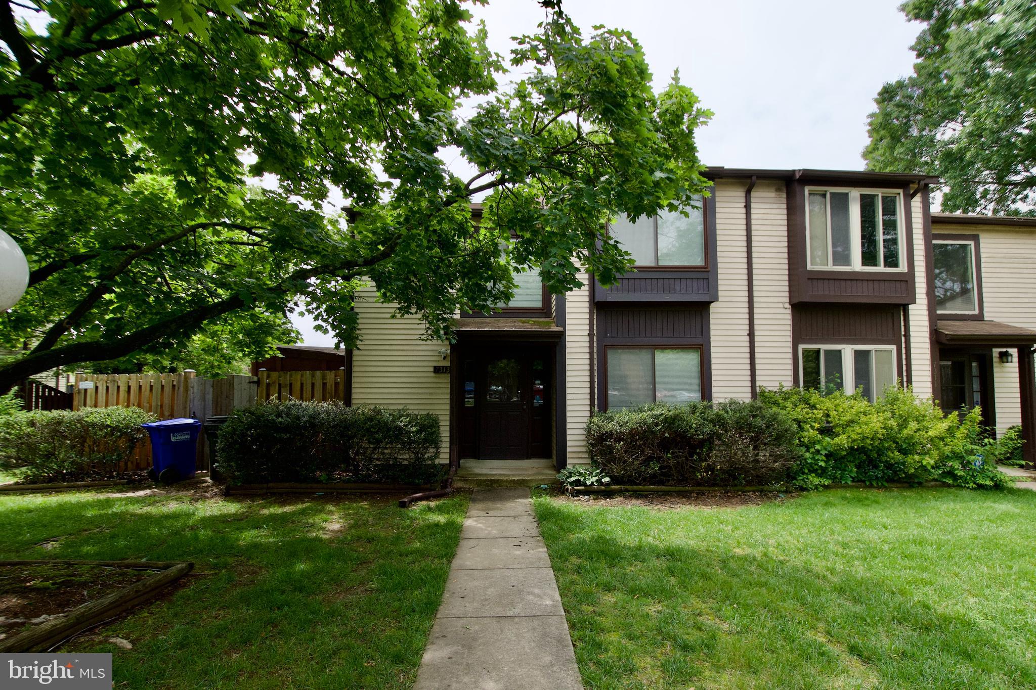 This is one of the rarely available models with the drama of the two story entrance foyer with an eye catching light fixture and an open concept where you can see the full span of the main level. The kitchen will grab your attention with the modern look and color of the 42 inch cabinets, stainless steel appliances and hard surface countertop as you walk through the door. The living and dining rooms have hard surface flooring, an angled fireplace and gracious room sizes for oversized furniture. The side yard has ample space for the grill, patio table and umbrella for those summer cookouts. The upper level has two spacious en suites with ample closet space, hard surface flooring and updated bathrooms. There is ample visitor parking available. The AC unit, water heater, fence, washer and dryer are new to nearly new. This property is conveniently located in proximity to major highways and shopping. Put this one on the list. It'll be sparking and turn key.