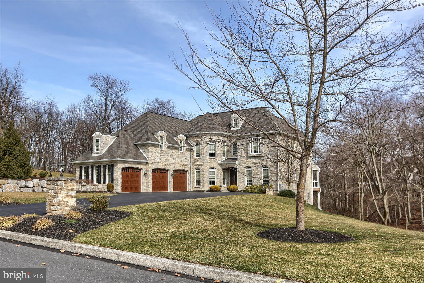Congratulations, you have discovered one of Central Pennsylvania’s most beautiful homes, pristine and rich with quality. Exceptional floor plan that provides space to detach from a busy world and amenities needed to make life easier. Crafted by a local builder known for exceptional detail and refreshing home designs. Located in Hampden Township, Cumberland County in the quaint community of Pinehurst Hills, a collection of fascinating homes with an ultra-convenient location and strong sense of community. Built of Ohio Limestone, this home is both stunning and easy to maintain. From the moment you glance upon the front entrance, you will immediately realize the attention paid to detail and deep quality throughout the home. Front entrance with grand foyer that flows into a large open family room with vaulted ceiling, detailed columns, built-in cabinets, shelves, fireplace, and rear wall of floor to ceiling windows with transoms and French door that opens to a large composite deck and covered cabana overlooking rear and side yard with a natural stream. First floor bedroom suite with private bath and walk in closet that is perfect for guest. Hearth room with ceramic tile floors, beautiful windows, cathedral ceiling with beams and a stone fireplace. Spacious gourmet kitchen with tile floors, granite counters, large center island, cabinets that tower to ceiling with elaborate trims and Thermador kitchen appliances. Formal dining room with crown molding, hardwood floor, chair rail and crescent transoms above windows. Mud room that is located just off garage with separate exterior exit, cabinets, coat rack and wash sink. Very clean three bay garage with newer 8’ overhead automatic doors with blue tooth technology and utility sink for clean ups. Recently refurbished second floor master suite with Kohler soaking tub, double bowl vanity with ornate cabinetry, tile shower with glass door, two walk in closets with organizers and a sitting area with trayed ceiling, hardwood floors and three-sided gas fireplace. Third bedroom is currently used as a second-floor laundry room with built-in cabinets, sink and tile floor, closet, and has access to a full bathroom and can serve as bedroom or laundry room by simply moving laundry to main level mud room. Second floor balcony-bridge that overlooks family room and foyer and leads to Jack and Jill bedrooms with two separate vanities and walk in closets. Finished basement with an abundance of natural light, exposed to rear yard with concrete patio. Game/Media room that is presently used as a music studio and is super versatile. Office with lots of windows, file closet and separate exercise room. There is also a rear entry one car integral garage that is fully drywalled and heated and can be converted to add more finished living area and is ideal for a workshop. Other quality features are a Luxor FX Luminaire LED landscape color lighting system that can color the home’s exterior and grounds to numerous festive colors to suit any occasion. New ShurFlo 6” gutter guards and improved underground gutter drainage system, new first alert AC powered central fire alarm system with 10 year battery backup, good through 2033, new custom window coverings, two new high efficiency Trane HVAC systems that deliver efficient state of the art heating and cooling, and Bradford White 75-gallon gas water heater (with circulating system) with 10-year warranty good to 2032. All in all, this home delivers 5,390 square feet of finished living area and has been well maintained and looks like new. Owners have loved and maintained this home extremely well and are looking for a new owner who will love it the way they do.