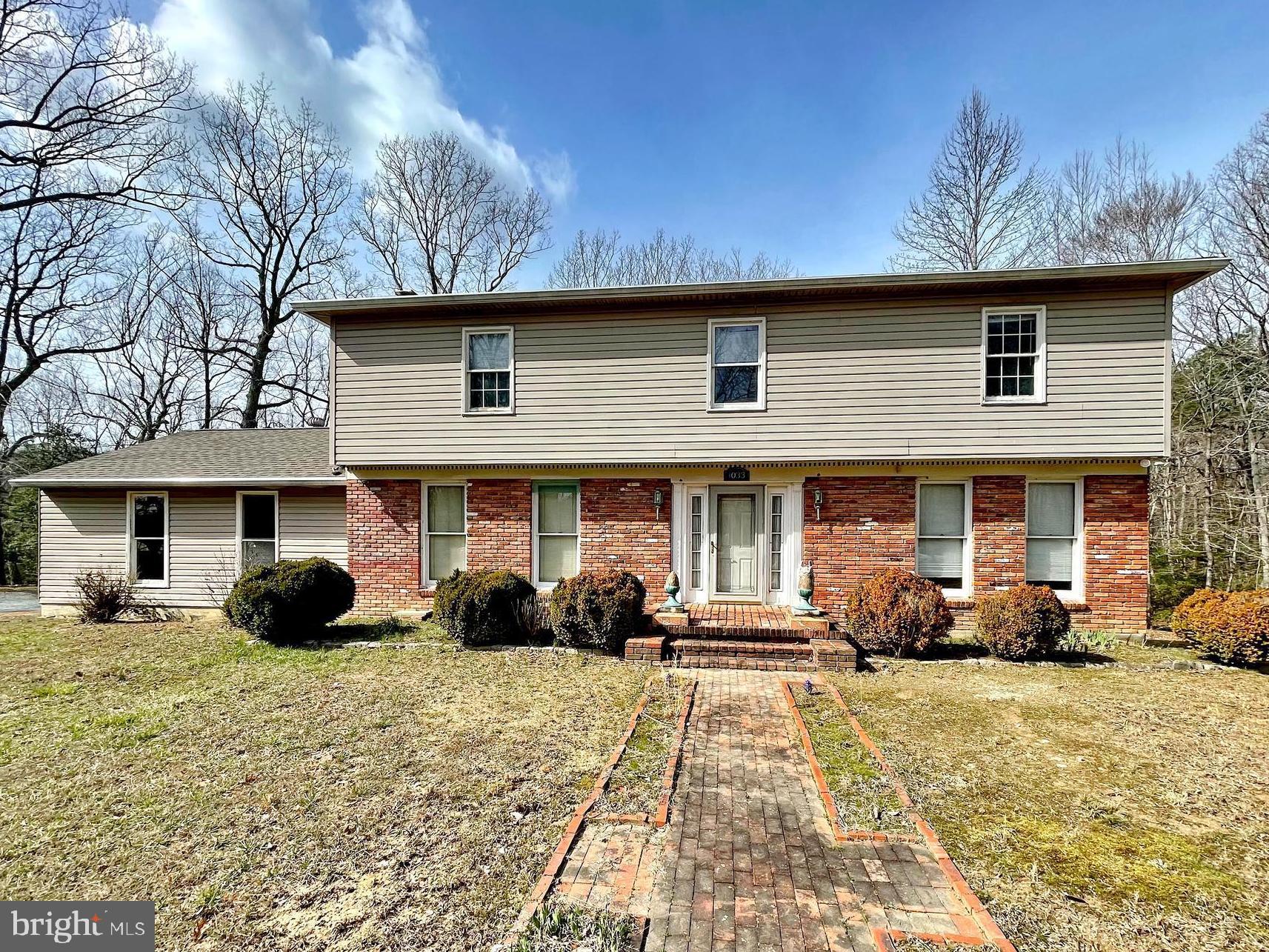 Welcome to 1033 Hyland Lane in Lusby, Maryland. This two-story colonial-style home rests on a generous 4.5-acre lot, quietly positioned off a private road. Offering ample space and potential, it's an inviting opportunity for investors or those seeking a project with promise.
Upon entry, discover two spacious rooms adorned with French doors and parquet wood floors. One serves as a comfortable living area, complete with a convenient powder room and laundry space, while the other provides a cozy family room ambiance with a wood-burning stove. The kitchen and adjacent dining room boast ceramic tile flooring and exterior French doors that lead to a deck overlooking the property.
Upstairs, four bedrooms and two full baths to contribute to the almost 2,400 square feet of finished space for this home. The basement is unfinished.
Though sold as-is, recent updates include a replaced roof in 2015 and a new HVAC system in 2022, with gutters and downspouts added in 2019.
Priced attractively below market value, this estate sale presents an opportunity for buyers to envision the potential and make it their own. If you're intrigued by the prospect of customizing a property to suit your vision, schedule a tour of 1033 Hyland Lane today. Explore the possibilities and imagine the future this spacious colonial home could hold for you.