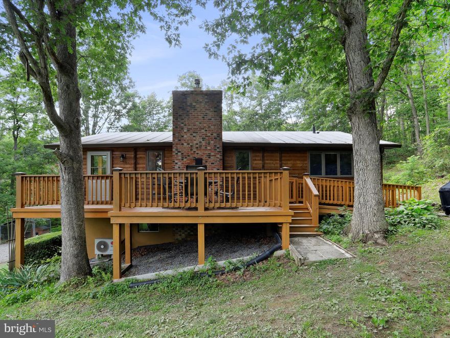 Your own private country retreat is waiting for you! Hunt, Fish, Hike or just relax on 20 secluded, unrestricted acres in beautiful Hampshire County! Enjoy getting out in  nature? Explore the atv trails through the woods, fish in your own private, stocked pond, or just relax on the deck and take in the views. Want to garden? The large garden plot  with green house is planted with fruit trees, berries, asparagus and hazelnuts. A large .25 acre food plot feeds the wildlife. Space to bring your animals too! Multple out buildings including a small barn with stall and hay storage, a wood shed, storage shed and lean-to for equipment just built this year. The house itself is surrounded  with flagstone walks and patios, and flowers from spring. through fall. When you do head inside, you won't be disappointed.  Cedar log walls, stone hearth, high ceilings and exposed beams give all the charm of a rustic cabin, Relax by the cozy woodstove on those chilly night, enjoy the spacious kitchen with Hickory Cabinets and plenty of counter space, and bright sun room with large windows lets you enjoy the views year round. Home has been meticuously maintained with many updates. New light fixtures throughout, new wood burning fireplace upstairs and propane stove in the basement offer alternative heating options,  updated primary bathroom, new flooring in primary bedroom, bathroom and hall, new gutters with leafguard system, new water heater and water filter, 50 amp whole house generator hook up, deck is freshly stained. All this and just a quick 15 minute drive to Hospital, Shopping, Pharmacy and restaurants. For those who work from home or stream, Frontier Fiber is available for internet. Seller is offering a 1 year Home Warranty.