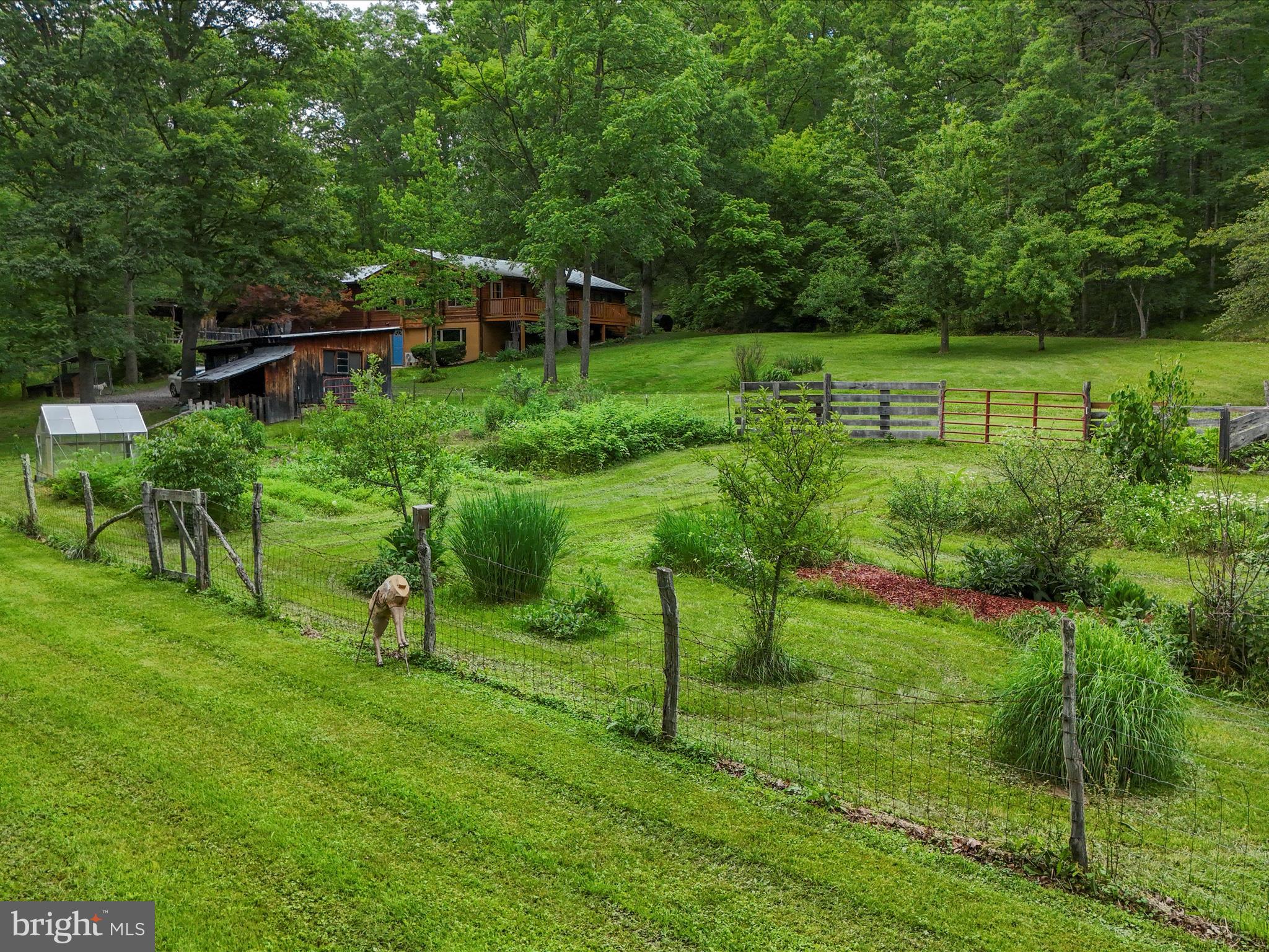 Looking for your own private country retreat or private homestead? This beautiful, 3 bedroom, 2 bathroom log home on 20 secluded, unrestricted acres has it all! Enjoy getting out in nature? Explore the atv trails through the woods, fish in your own private, stocked pond, or just relax on the deck and take in the views. Want to garden? The large garden plot with green house is already planted and yard is planted with fruit trees, berries, asparagus and hazelnuts.. Space to bring your animals too!Multple out buildings including a small barn, wood shed, storage shed and lean-to just built this year. The house itself is surrounded with flagstone walks and patios, and flowers from spring. through fall. When you do head inside, you won't be disappointed. Cedar log walls, stone hearth, high ceilings and exposed beams give all the charm of a rustic cabin, Relax by the cozy woodstove on those chilly night, enjoy the spacious kitchen with Hickory Cabinets and plenty of counter space, and bright sun room with large windows lets you enjoy the views year round. Home has been meticuously maintained with many updates. New light fixtures throughout, new wood burning fireplace upstairs and propane stove in the basement, updated primary bathroom, new flooring in primary bedroom, bathroom and hall, new gutters with leafguard system, 50 amp whole house generator hook up, deck is freshly stained. Seller uses Frontier Fiber for internet. By appointment only! Do not enter property without an appointment.