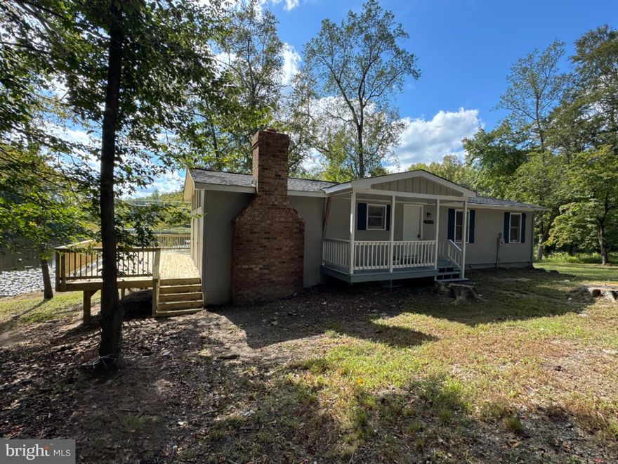 Welcome Home to 26374 Hill Road, Ruther Glen, VA – a charming lake front retreat nestled in the heart of Caroline County! This delightful 4-bedroom, 2-bathroom home offers 1,404 square feet of living space, perfectly situated on a serene waterfront lot.

Step inside to discover a spacious layout featuring a large family room with a wood-burning fireplace and walls full of sliding glass doors with gable transom windows inviting the outside in. Step out on the incredible brand-new 600+ sf deck, ideal for relaxing evenings. The kitchen is equipped with new appliances including an electric range, built-in microwave, and dishwasher, making meal prep a breeze (no refrigerator). LVP floors flow throughout the entire home, adding warmth and character.

Outside, enjoy the tranquility of waterfront living with ample space to unwind or entertain overlooking the lake. The expansive lot offers opportunities for gardening, recreation, or simply soaking in the natural beauty. This property features a private dock (needs a little TLC), that you can launch your canoe or kayak, or simply hang out and fish.

Conveniently located just minutes from I-95, this property provides easy access to both Northern Virginia and Richmond, blending rural charm with modern convenience. Items replaced in 2025: deck, architectural roof, water heater, LVP flooring, most windows and doors, kitchen, main hall bathroom, interior and exterior painting, light fixtures, appliances, kitchen cabinets.