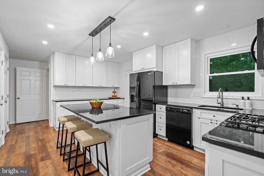 $25K PRICE IMPROVEMENT! Stunning updates and a rare main-level suite in sought-after West Springfield! This beautifully updated 5-bedroom, 3-bath home offers the perfect blend of style, function, and location - nestled on a quiet cul-de-sac and backing to the serene Pohick Stream Park in Rolling Valley. Pull into your private driveway and step into the spacious foyer, where you're greeted by gleaming, hard-surface flooring and abundant light throughout the main level. The gracious living room with large bay window flows seamlessly into the large dining room, both perfect for entertaining. The gourmet kitchen features an island with bartop seating, white shaker cabinetry, and top-tier appliances. One of the standout features of this home is the rare main-level bedroom suite complete with laundry and an adjacent full bathroom - ideal for a den, guests, or multi-generational living. Upstairs, you'll find four additional bedrooms, including the generously sized primary bedroom with a luxurious ensuite bathroom, and an additional contemporary hall bathroom. The spacious walkout basement offers additional living space and flexible use, as well as a second laundry room and unfinished storage space. Extra storage is also plentiful in the upstairs attic. Enjoy outdoor living with a covered upper deck off the kitchen as well as stairs leading to an expanded lower deck, all overlooking lush woods and the protected parkland. Brand new, professionally crafted retaining wall, a $40,000 investment, which enhances the property and provides long-term landscape stability. Located in the highly rated West Springfield High School pyramid, this home is also just steps from Rolling Valley Elementary, Hidden Pond Nature Center, Village West Pool (membership available), and Springfield Golf & Country Club. You're also mere steps to shopping and dining options at Cardinal Forest Plaza, including Starbucks and Trader Joe's, and just minutes to Whole Foods, Starbucks, and more at Springfield Towne Center. Commuters will love the easy access to the VRE, Franconia-Springfield Metro, and I-95. This is more than a home—it's a lifestyle. Welcome to 6703 Portree Ct!