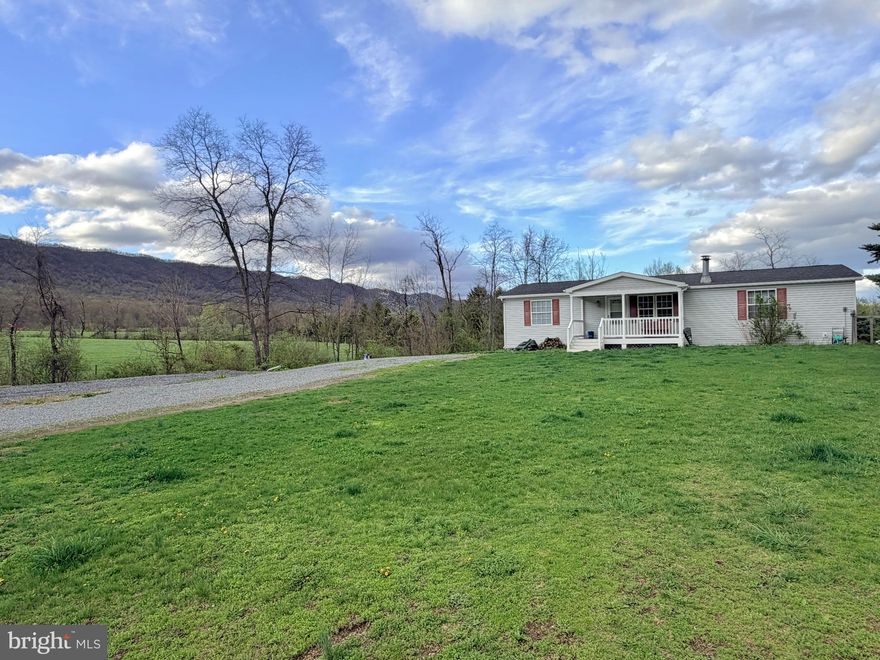 Updates have been completed including a brand new shingled roof, new shower in primary bath, new tub/shower in secondary bath, also including some painting and trim, etc.  This home is now ready for all loan types! Nestled on a quiet dead-end street with beautiful mountain views, this 2002 manufactured home offers space, comfort and incredible potential.  The main level features over 1400 sq ft with a bright, open layout, 3 bedrooms and 2 full baths, and generously sized rooms throughout.  All bedrooms include walk-in closets, while the primary suite boasts a large bath with separate soaking tub and shower.  The kitchen offers excellent storage with an island and large pantry.  On the lower level, the full finished basement provides tons of additional living space and flexibility for a family room, home office, gym, hobby area or additional bedrooms.  On the exterior, you'll find both a covered front porch and a rear deck - perfect for relaxing and entertaining along with a nice stream traversing through the property. Large yard for the kids, animals, etc.