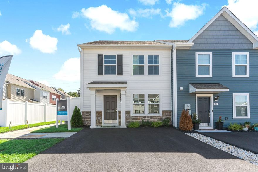 Your chance to own a beautiful MODEL HOME!! This End-Unit 2 level home has plenty of upgrades including custom window treatments and paint throughout! It offers both beautiful and efficient living space with a 4 car driveway. The main level features luxury vinyl plank flooring and a spacious living room that leads to the well-appointed modern kitchen featuring, stainless steel appliances, Quartz countertops, upgraded cabinets, large island, pendant lights, backsplash and an adjacent dining area. Enjoy the nice 15 X 12 rear patio backing to woods. The primary suite features a generous walk-in closet and an ensuite bath with dual sink vanity and 5 ft. walk-in shower. Two secondary bedrooms, full bathroom and conveniently located laundry complete the second floor. This home features 2 ft. x 6 ft. exterior walls (R21 and R49 insulation) Lennox Central HVAC! Great location between Inwood and Charles Town! Best buy in the county! Quiet country living and still close to so much! Whispering Pines community features the special blend of small town charm and accessibility to everyday conveniences. Choose between the areas premier shopping and dining only 11 minutes away or go local at popular Orr's Farmers Market. Located along the gateway to the Shenandoah Valley Region minutes from I-81 this community also offers a short 20 minute commute to Winchester, VA. Within minutes to I-81, three miles from Inwood, ten miles to Golf Course and seventeen miles to Loudoun County. ***Builder rent back needed***