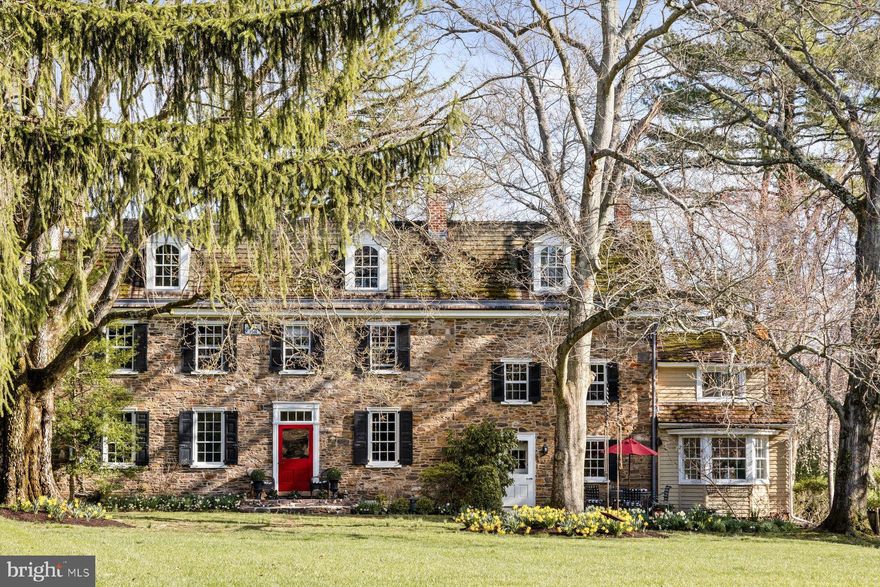 Set gracefully back from the road on nearly two acres of lush grounds is this exceptional Bucks County Stone Manor home, known as Te Deum.  Located between New Hope and Newtown, PA the picturesque retreat offers a rare blend of timeless beauty, thoughtful restoration, and versatile living space. Originally constructed in 1769  and significantly enlarged in 1831,   the home has been lovingly restored by its current owners, preserving original details while introducing modern comfort and thoughtful design. Nestled in a peaceful, park-like setting with mature trees, vibrant gardens, and views of a neighboring pond, the long private drive welcomes you beneath one of the oldest trees in Pennsylvania, setting the tone for this extraordinary offering.  Inside, the sunny home features antique pumpkin pine floors, deep window wells, and custom millwork throughout its three spacious stories. The gracious family room centers around a stunning walk-in stone fireplace and opens to both front and rear gardens, perfect for everyday living or entertaining. Four working fireplaces, each chimney professionally relined, add warmth and historic charm to the space.  The main level includes living room, family room, an elegant dining room with Delft tile fireplace surround and custom cabinetry, a modest kitchen with built-in seating and cherry wood cabinetry, and a comfortable guest room with bath/laundry.  Upstairs, the versatile layout includes a primary suite with fireplace and garden views, a custom designed home office with cherry cabinetry, additional bedrooms with flexible adjoining spaces, and beautifully tiled hall baths. The third floor boasts additional bedrooms or creative bonus areas ideal for creative endeavors or fitness. Each room is filled with natural light and historic detail.  Zoned R2, the property allows for a multitude of uses including a professional office, boutique inn, … Ideally situated near I-295 and the Delaware River, this home offers quick access to Princeton (25 minutes), Philadelphia (30 minutes), and New York City (80 minutes), with the Yardley Train Station just five minutes away. Don’t miss your opportunity to own a truly remarkable piece of Bucks County history, where grace, privacy, and possibility come together.