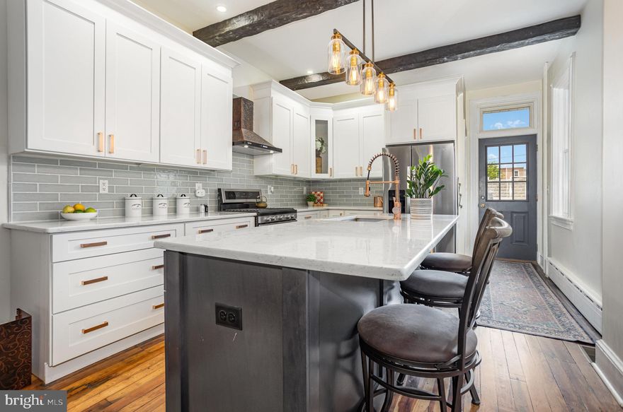 This beautifully updated 5 BR, 2BA  home offers 2,200+ sq ft of flexible, light-filled living space in a prime Lancaster location with easy access to highways, shopping, and walking distance to downtown. Plus, a rare find in the city: a two-car garage with a brand new roof! Enjoy your morning coffee or a cozy evening rainstorm from the spacious covered front porch.  Inside, you'll find a perfect blend of classic charm and modern updates, including 9-foot ceilings, original wood trim, exposed ceiling beams and brick, and stunning hardwood floors throughout. The renovated kitchen is a standout—featuring quartz countertops, tile backsplash, a large island, and stainless steel appliances—designed for both function and style.  Upstairs, the second floor boasts three bedrooms, a renovated full bath, a convenient laundry room, and elegant architectural details like wood flooring, crown molding, glass transoms, and a unique balcony overlooking the kitchen/living space. The third floor offers two additional bedrooms, making this home perfect for families, guests, or home office needs.  The large basement provides generous storage and direct walkout access to the private, fenced backyard—complete with a patio, garden space, and a storage shed.  Additional features include ample closet space, a newer AC system, low-maintenance exterior and much more.  Don’t miss your chance to own this move-in ready home with unmatched charm, convenience and modern comforts. * Offer deadline is 6pm on Thursday, 5/29/25.