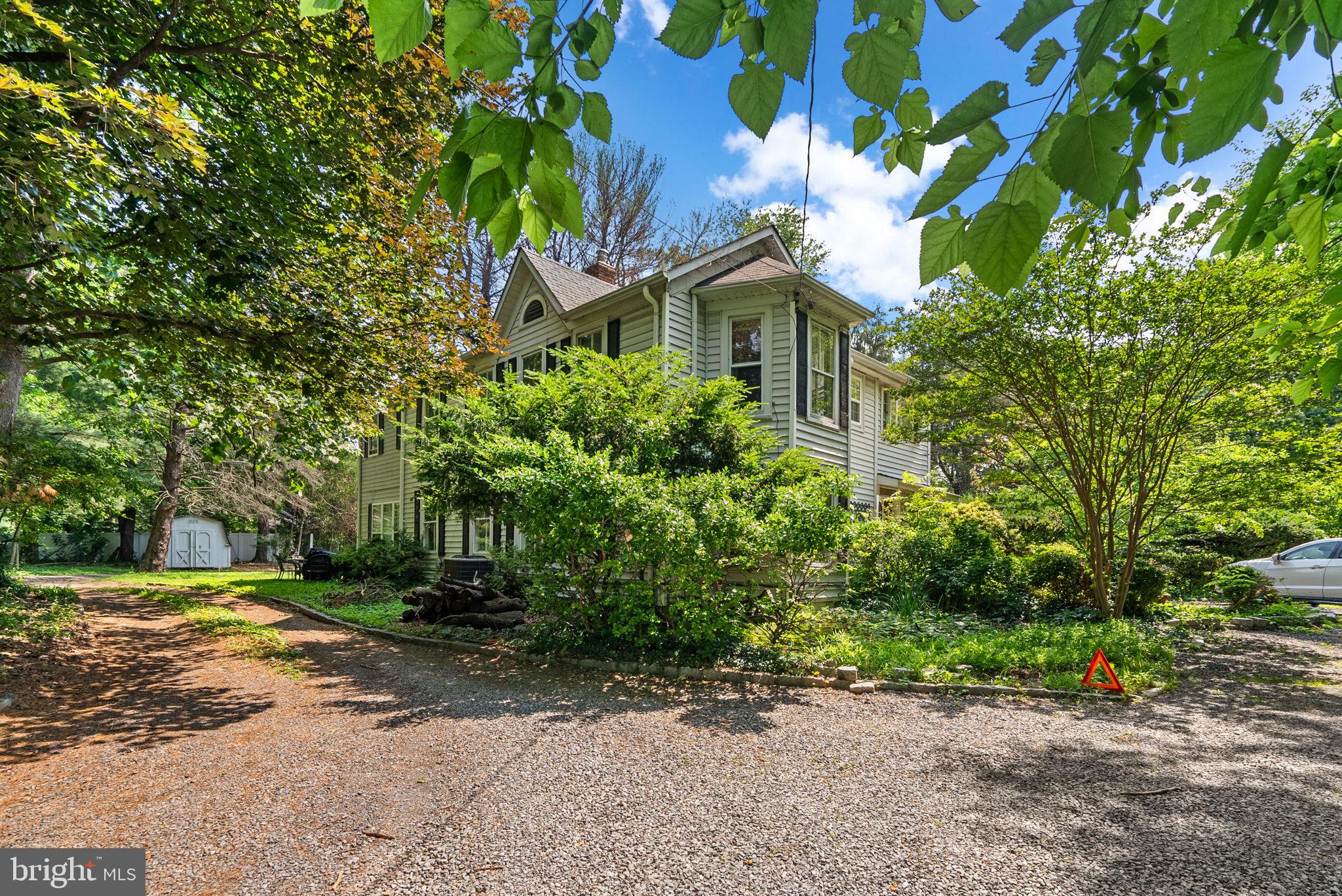 Welcome to this bright and airy 4 bedroom, 2.5 bath Potomac home that has the charm of 1890 (built as part of the Mt. Prospect Estate), but also all of the modern amenities, including the 2 story addition. As you drive in to the idyllic property, you are instantly calmed by the privacy it provides with its sprawling 1 acre lawn and 100+ year old specimen trees. The entry of the house welcomes your guests into the charming foyer complete with a bay window, built ins, and a shiplap ceiling. Next you will enter the spacious pine-paneled dining room, which has built in storage, brick detail, and decorative beams. The living room has original wood floors, a wood-burning stove, and double doors that open up to another living space with floor to ceiling windows. The main level also includes an updated kitchen with large island and 3 closets, a half bath, and a kitchenette in the addition. Upstairs is the primary bedroom suite which has its own staircase off the kitchen, and includes a huge full bath with soaking tub, standing shower, and plenty of storage, a walk in closet, and spacious bedroom area. The upper level also includes 3 other bedrooms, including a bedroom with an attached office/studio and a pine-paneled room with built ins, a laundry room and a full bath with skylight. The house includes many original details such as door locks with key. Note that the house is currently divided so that there is an owner's side and a tenant's side, however, there is no permanant division and can be utilized as one space with one main entrance. Don't miss your chance to own a piece of Montgomery County history!