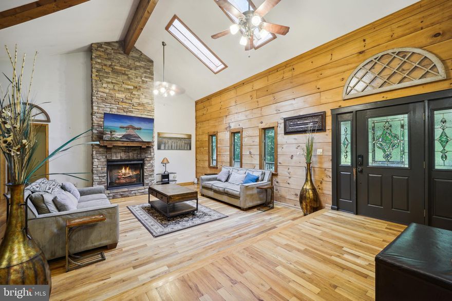 Secluded 5.48 -Acre Log Estate with Guest Apartment & River Access
Tucked away among mature trees on on close to six private acres, this distinctive log estate offers a peaceful country retreat near the Port Tobacco River, combining privacy, nature, and flexible living space in a beautiful setting.

Located within convenient reach of Washington, DC, La Plata, and surrounding Southern Maryland communities, the property offers the perfect balance of accessibility and seclusion for those seeking a full-time residence or a private weekend escape from the city.

With more than 5,000 square feet of living space, the home blends rustic character with modern comfort. The main level features soaring ceilings, exposed beams, and expansive windows that bring natural light into the spacious living areas, creating a warm and inviting environment for everyday living and entertaining.

The updated kitchen includes granite countertops, stainless steel appliances, and generous space for gatherings with family and friends.

The recently renovated owner’s suite features a beautifully updated bathroom, while additional bedrooms provide flexibility for guests, family members, or work-from-home space.

The fully finished lower level adds exceptional versatility with a second kitchen, additional bedrooms, a full bath, and office space—ideal for multi-generational living, extended guest stays, or private living quarters.
Adding even more flexibility, the separate apartment above the detached garage offers its own entrance, kitchen, and living area. This space can serve as a guest suite, home office, private retreat, or potential rental opportunity.

Outdoor living is where this property truly shines. Wraparound porches, patios, a swim spa, fire pit, koi pond, and expansive deck areas overlook the surrounding woods, creating a peaceful environment perfect for entertaining or relaxing in nature.

Residents also enjoy community access to the Port Tobacco River, including a private pier and boat ramp for boating, kayaking, fishing, and outdoor recreation just minutes from the home.  Unlike traditional suburban homes, this property offers a rare opportunity to enjoy private estate-style living surrounded by nature while still remaining within reach of regional amenities.

Seller welcomes serious inquiries and will consider strong offers.
Schedule your private showing to experience the charm, tranquility, and lifestyle this unique property has to offer.