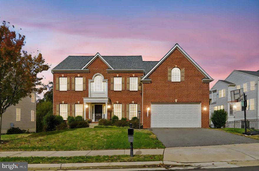 Welcome home to refined living in the Seven Hills enclave of Dulles Farms. Built in 2012 with an elegant brick front, this classic Colonial blends upscale finishes with everyday comfort and flow.

Inside, an inviting open concept connects the gourmet kitchen—island seating, upgraded countertops, and excellent storage—to the family room and sunroom, creating the perfect hub for both entertaining and easy daily living. The formal dining room is framed with chair rail and crown molding for a touch of sophistication. A gas fireplace with glass doors anchors the main level for cozy evenings in.

Upstairs, four spacious bedrooms anchor the private level, while the 5th bedroom sits on the walk-out lower level—ideal for guests, multigenerational living, a home office, or au pair suite.  The luxury primary bath is a serene retreat designed for unwinding at day’s end.  Downstairs, a full, finished-ready basement with connecting staircase delivers exceptional potential —think home gym, media lounge, play space, or guest suite—tailored to your lifestyle.

Outdoor living shines on the spacious Trex deck overlooking a 0.22-acre lot, ideal for gatherings, grilling, and quiet morning coffee. The attached 2-car garage includes electric vehicle charging, adding convenience today and value for tomorrow.  Major updates include a new roof (2022) and one gas furnace replaced (2024) for added peace of mind.

Community perks:  Dulles Farms delivers two clubhouses with pools and fitness rooms, miles of trails, courts, tot lots, a dog park, and beautifully maintained common areas—resort-style living minutes from home.

The one that checks every box—tour today.