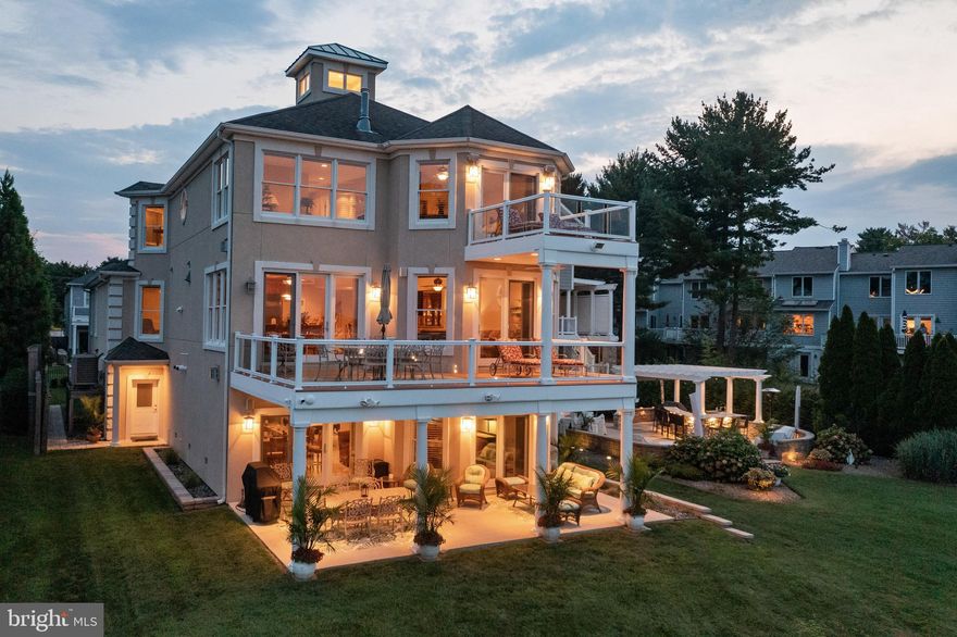 Dreaming about lounging on a private beach with your toes in the sand next to a waterfront Tiki bar? Make that dream an every day reality at this truly special waterfront property! Standing proudly amongst multi million dollar waterfront properties and overlooking the sandy shores of the Magothy River out to the Chesapeake Bay, this perfect 4 bedroom 4.5 bath home in Arnold checks all the boxes for a coveted waterfront family home; deep water private pier, public water and sewer, plus a great school district and captivating water views from morning to night! The main level open floor plan allows you to enjoy the views from the kitchen, dining room and living room and draws you out to the spacious deck with glass railings to take a closer look. The gourmet kitchen is equipped with high-end appliances and adjacent butler's pantry to suit any chef's needs. 2 Bedrooms with shared bath and comfy theater room provide one level living but the convenient elevator provides easy access to the additional floors. The upper level boasts the Primary bedroom suite with panoramic water views, private balcony, 3 sided fireplace, gracious sitting area, custom closet and spa like bath. The other wing of this level provides an additional ensuite bedroom for privacy and comfortable accommodations.  The party is in the lower level with enormous wet bar, game room, multiple TV's, 2nd kitchen and full bath perfect for hosting parties of all sizes and creating a lifetime of memories with family and friends with gatherings that spill out onto the back patio and yard. Feel your worries melt away during the short walk to your own private beach front tiki bar; a perfect place to unwind after a long day or refresh before a fun day out on the water.  Launch some kayaks or head out on a long cruise from the 11' MLW private pier, fully equipped with lights, water, shore power outlets and 3 boat lifts; stretching out into the Magothy River with easy access to the Chesapeake Bay and beyond. The perfect location that is sure to please everyone from the novice to the experienced boater. Located in the Blue-Ribbon Broadneck School district and just 5 miles to downtown Annapolis and Severna Park. Convenient to Baltimore, BWI, Ft. Meade/NSA and Washington, DC. You literally have the best this region has to offer in a 30-mile radius. Welcome Home!