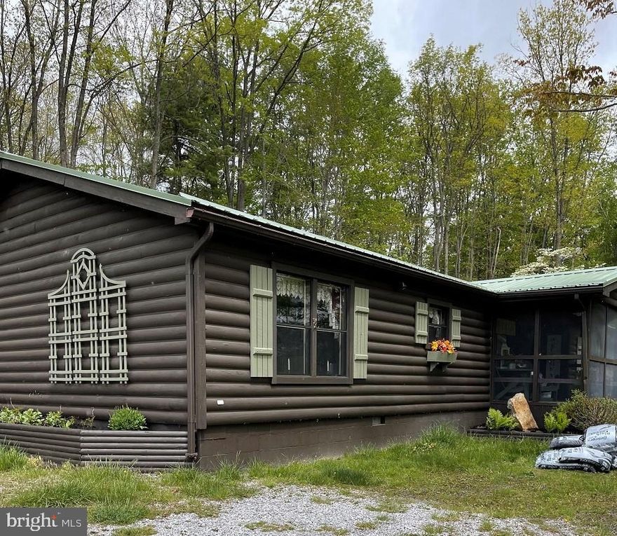 IMMACULATE  HOME! Enjoy the comfort of quiet country living while being close to all the amenities of a small town.  This charming, 2 bed (could convert to 3), 2 bath Ranch log siding home sits on 3.12 acres.  Baths have been very tastefully remodeled recently. The beautiful room built above the cellar just off of the back deck is sure to be a guest favorite.  Heat Pump & Central AC, Screened-in front porch for relaxing and viewing the abundant wildlife in the area. Two utility buildings with electric & Cold Cellar. Well & Septic.  Make an appointment today!