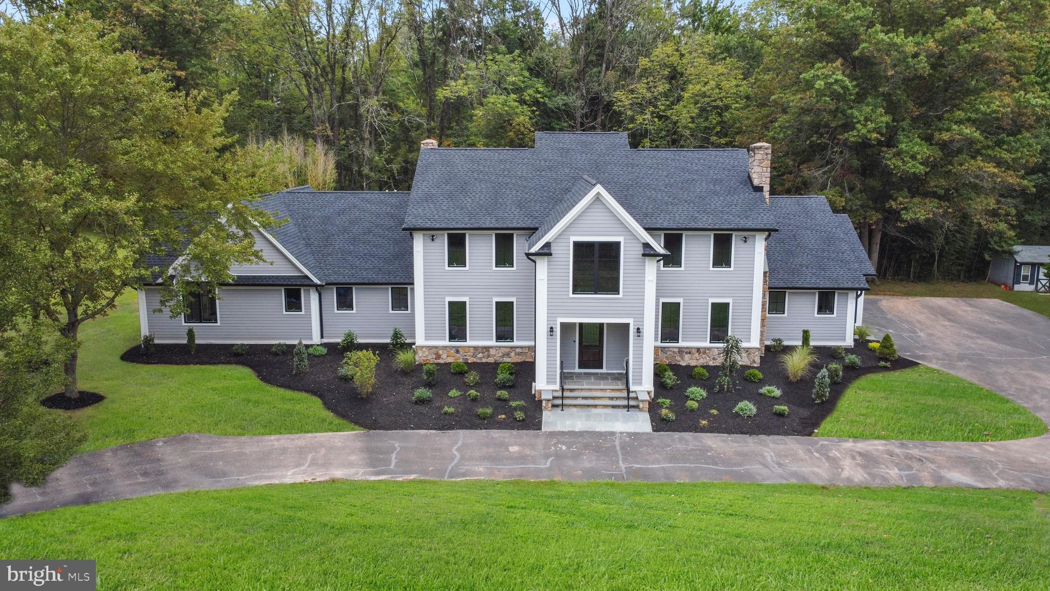 Now available for showing! Every inch of this splendid home has been completely renovated and expanded, designed to impress even the most discerning buyers! Now with over 5,000 SF of living space, this gem offers exemplary living space. Enjoy the scenic approach to the house from either entrance of the horseshoe-shaped driveway, surrounded by almost five private acres of sprawling lawn and shade trees. There is a luxurious 1,000 SF 1st floor master suite with separate sitting room, stone fireplace, large walk-in closet and fabulous bathroom! There are 2 bedrooms on the second floor, and one on the third floor. All bedrooms are spacious, with en suite full baths! The gourmet, eat-in kitchen with high end appliances offers is thoughtfully designed for and perfect for entertaining. Fabulous great room, dining room, home office, and more. The floor plan lends itself well to multi-generational living. The builder is also available to review expansion ideas with interested buyers (Au Pair suite, in-law quarters, etc.) New septic! Ample parking for multiple cars. Ready for occupancy. New Hope-Solebury School District!