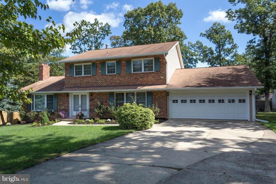 Spacious & sunny brick-front model in sought-after Wynfield!  Move-in ready home w/ hardwoods, updated appliances, & a fully finished walk-out basement w/ 2nd kitchen.  Grill out/relax on expansive deck w/ built-in seating overlooking mature trees and foliage.  Tons of storage w/  600 sq. ft. 2 car garage.  Fabulous location inside the Beltway near major commuter routes & Mason District Park.