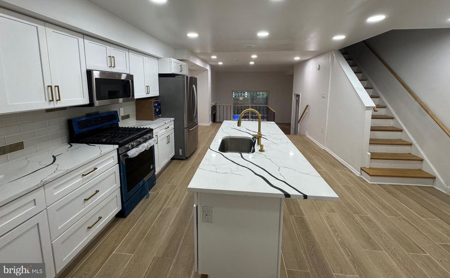 Welcome to 639 Lombard Street, a beautifully maintained 3-bedroom, 2.5-bath home nestled in the heart of historic Society Hill. Spanning three spacious levels, this residence offers a perfect blend of modern upgrades and classic charm. The main level boasts a stylish, updated kitchen with a center island, stainless steel appliances, and generous cabinet and counter space—ideal for both everyday living and entertaining. Step down into the sunken living room featuring a cozy wood-burning fireplace and sliding glass doors that open to a private, fenced-in patio, perfect for outdoor relaxation. A convenient powder room completes the main floor. Upstairs, you'll find three well-proportioned bedrooms, including one with a sunny south-facing balcony. Two full bathrooms are located on this level, one of which has been fully renovated and features a sleek glass-door shower. The finished basement offers additional living space with warm wood paneling—ideal for a home office, gym, or rec room. Private off-street parking is included. Located just steps from Washington Square, shops, and dining, this home offers comfort, convenience, and character in one of Philadelphia’s most desirable neighborhoods.