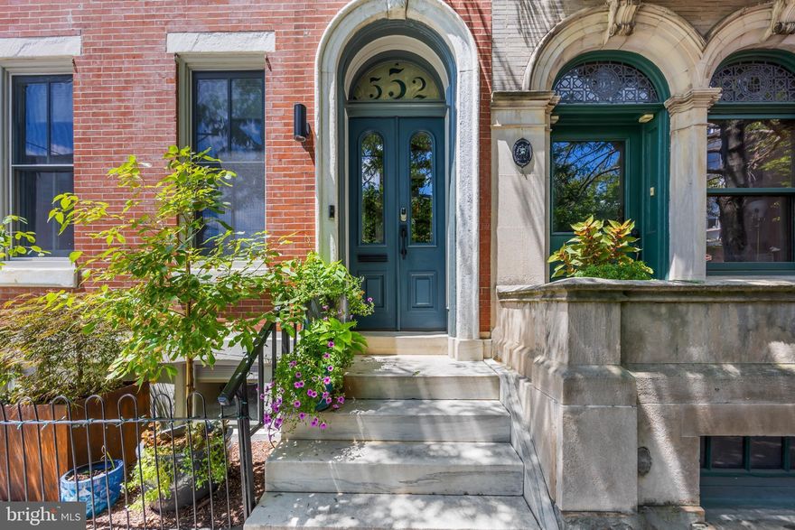 Nestled in the heart of Fairmount, this exquisite corner property at 18th and Brandywine seamlessly blends traditional charm with modern luxury. Built in 1920, the home boasts a timeless brick façade that welcomes you into a world of elegance and comfort.  Inside, you'll find a warm and inviting interior featuring rich wood floors, 11-foot ceilings, and classic crown moldings that add to the sophisticated ambiance. The first floor offers incredible flexibility with an au pair or guest suite complete with a full kitchen, separate laundry, and a private entrance; ideal as a separate apartment. There's also a second bedroom on this level with a stylish en-suite bath. Upstairs, natural light floods the open main living space, perfect for entertaining. The gourmet kitchen is a chef’s dream, equipped with Monogram appliances including a six-burner stove, convection oven, and a paneled refrigerator.  A striking 16-foot quartz island with waterfall edges anchors the room, complemented by ample custom cabinetry for storage and radiant floors. French doors open onto an expansive rear deck, adding approximately 500 square feet of outdoor living space, including a gas line, ideal for summer BBQs. The bright and spacious living room features a sleek electric fireplace and a wet bar, making it the perfect place to unwind or host guests for those holiday dinners. Retreat to the luxurious primary suite, complete with a spa-inspired en-suite bathroom featuring radiant heated floors, a soaking tub, and a frameless glass walk-in shower. The top floor also includes an additional walk-in closet, and another bedroom with its own well-appointed full bath, and a convenient secondary laundry area.  The finished basement provides valuable flex space that can serve as a bedroom, media room, or gym. Enjoy the added bonus of an in-home IR sauna, perfect for post-workout recovery.  There is also another full bath and the main laundry.  A true rarity in city living, the home includes an attached two-car garage.  The home is in the perfect location.  The Philadelphia Museum of Art, the Rodin Museum, and the Barnes Foundation are just steps away. Spend sunny afternoons in Fairmount Park or take a scenic stroll along Kelly Drive past Boathouse Row. The neighborhood is also home to a variety of great restaurants, coffee shops, and shopping like Jack’s Firehouse, Cantina Feliz, Bishops Collar, and Whole Foods.   With easy access to public transportation, the subway, and major highways (76 and 676), commuting is a breeze.  Homes like 552 N 18th St rarely come on the market. Schedule your showing today and make this exceptional home yours.